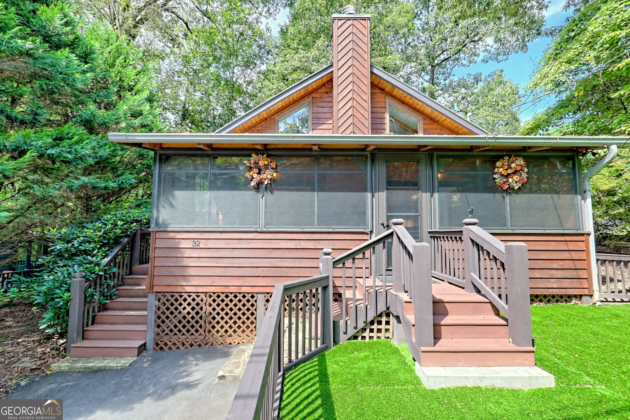 Prepare to fall in love with the most adorable, completely reimagined cabin near Lake Burton! Perfectly positioned within walking distance to Anchorage Marina, the Farmhouse Market, and Lake Burton Cafe, this property blends classic charm with extensive modern renovations for a one-of-a-kind retreat. Step inside and experience a thoughtfully opened floor plan featuring TWO dramatic nano walls that erase boundaries between indoors and outdoors, filling the living space with natural light and fresh mountain air. Both porches have been enclosed with premium 365 Porch Living systems, adding nearly 450 sq ft of flexible year-round living space---ideal for entertaining or relaxing with friends and family. The kitchen has been elevated to a chef's dream with a new leathered quartzite island, KitchenAid Cafe appliances, and an upgraded full-size washer and dryer. The bathroom was completely gut renovated with designer tile, frameless glass, and an Anthropologie vanity. The loft now boasts a new staircase and an added half bath, making it a perfect guest or bonus room. Fresh paint throughout, designer touches, and high-end furnishings add sophistication to this cozy mountain haven. Outdoors, the upgrades continue: the driveway was reconfigured and resurfaced for additional parking, the front yard was fenced and turfed for children and pets, and the wraparound deck with a grilling porch provides the ultimate spot for summer cookouts. Two authentic stone wood-burning fireplaces with gas starters offer cozy ambiance for cool evenings, and a dedicated storage shed keeps your lake gear organized. This is more than a cabin---it's a fully transformed getaway that combines timeless charm with modern convenience. Whether you seek a low-maintenance vacation home, an income-producing rental, or a stylish full-time retreat, 32 Hill Camp Ln delivers. Schedule your private showing today and experience the best of Lake Burton living!