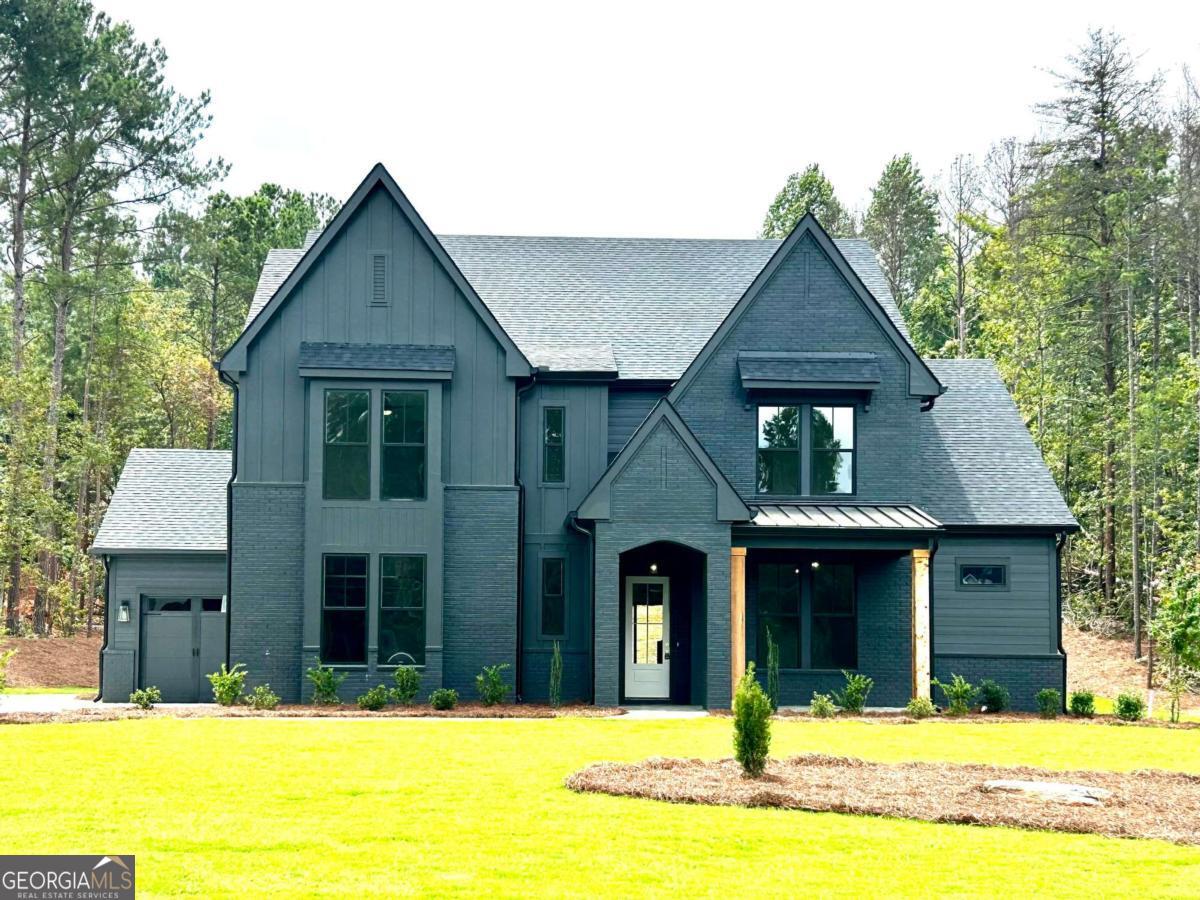 This exceptional NEW CONSTUCTION home offers high-end design, flexible living, and PREMIUM finishes-beautifully situated on a 1.5-acre lot in the GATED luxury community The Manors- zoned for top-rated Jefferson City Schools. The Abigail design features 5 bedrooms, 4.5 baths, a loft, and a 3-car garage. Every element has been carefully selected, with luxury finishes, custom craftsmanship, and attention to detail that elevate this home far beyond typical new construction. A RARE dual owner's suite layout with a primary suite on both the main and upper level ensures comfortability and flexibility. BOTH retreats boast spa-like baths and custom closets. The main level impresses with 10-foot ceilings and an open, sun-filled layout centered around a designer kitchen with a massive island, custom cabinets and a HIDDEN WALK-IN PANTRY. Just beyond, the spacious family room features a cozy fireplace, built-in bookcases, and sliding glass doors that lead to the covered back porch with a view of the large and PRIVATE backyard. Upstairs, the GENEROUSLY sized secondary bedrooms ALL have private bathroom access and LARGE closets. Each bathroom showcases curated tile details that feel custom and luxurious. A second laundry room upstairs adds extra convenience. Upstairs, the LOFT is a versatile retreat that offers endless possibilities to fit the needs that your lifestyle demands. This home is the definition of turnkey LUXURY and needs to be experienced in person.
