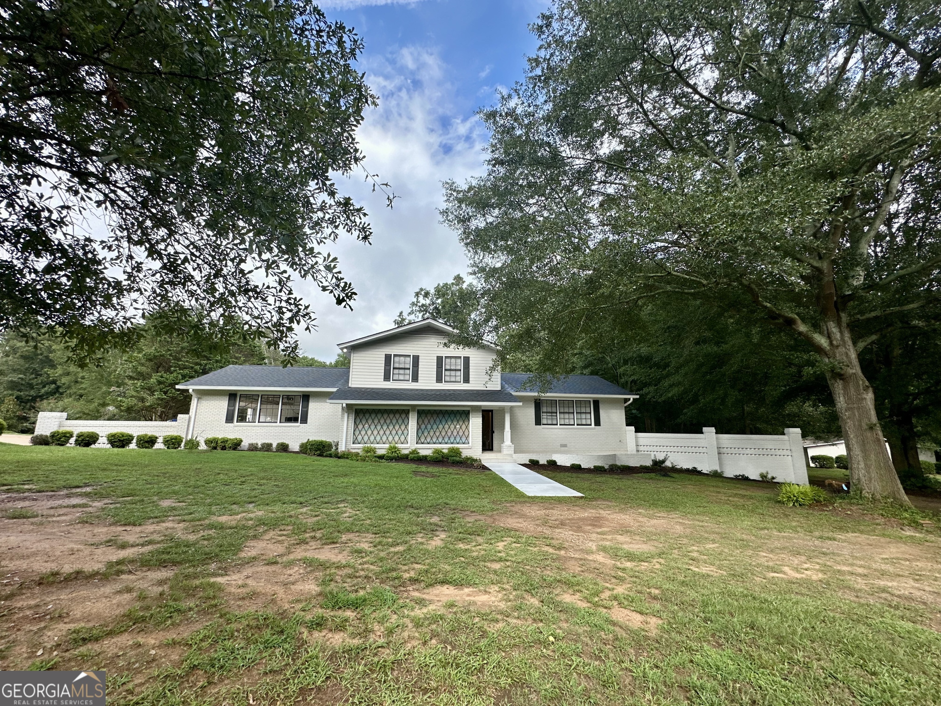 Gardner Wanted! Take over the well established grounds and make it your own. Set on a peaceful 5.32-acre parcel and buffered by two undeveloped parcels for additional privacy, this impeccably cared-for home blends timeless quality with subtle mid-century modern influences. Large windows and clean architectural lines invite in natural light and connect the interior with the surrounding landscape, while warm wood tones and original design details nod to its stylish heritage. Inside, you'll find spacious, sunlit living areas, thoughtfully designed built-ins, and an easy, flowing floor plan ideal for both relaxing and entertaining. Every surface and system has been meticulously maintained, reflecting pride of ownership and lasting craftsmanship. Outside, the expansive acreage offers open space for gardens, recreation, or simply enjoying the serenity of nature. With the house situated well off the road and limited access, road noise is virtually nonexistent. Mature trees, wide lawns, and picturesque views create a private retreat only minutes from local amenities. Horses are allowed on this parcel. Nice size dog pen included. There is a creek on the property. Conveniently located to Commerce, Banks Crossing at I-85 is a short 15 minute drive to shopping and restaurants. Athens and the University Of Georgia are 25 minutes away. This is a rare opportunity to own a move-in-ready home that combines vintage style, modern comfort, and the beauty of country living.