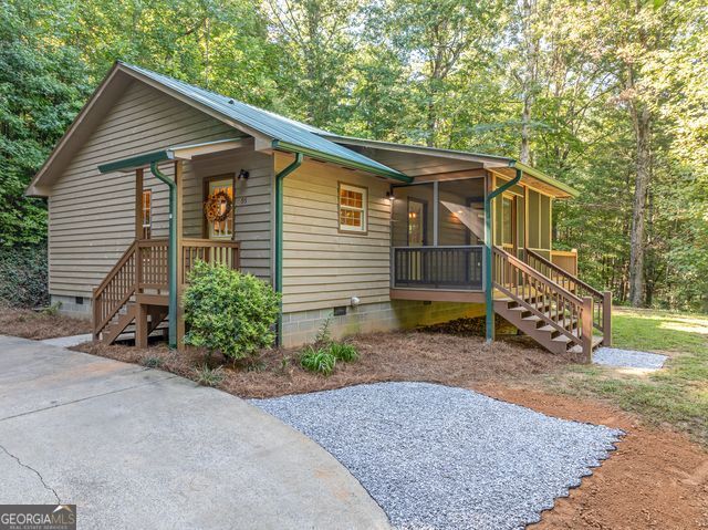 The Perfect Blend of PRIVACY, CHARM & LOCATION-Cabin Close to Everything! WELCOME HOME to this Cozy 2 BED/ 2 BATH Cabin featuring a Spacious Living Area with an Open Floor Plan. Nestled in a Private yet Easily Accessible Location, this Property Offers a GREAT Kitchen with Ample BRAND NEW Counter Space, NEW APPLIANCES, Abundant Cabinets, a Pantry, and even a Walk-In Pantry for all your Storage Needs. The Primary Bedroom is Generously Sized with a Private Bath and Large Closets. Step Outside to Relax on the SCREENED-IN PORCH, Entertain on the NEWLY STAINED Grilling Deck, or Enjoy the Large Yard Complete with a Perfect Spot for a Fire Pit or a Garden. Additional perks include NO HOA, FRESH PAINT Throughout and large Attic Space for Extras. This Cabin is an Excellent Opportunity to Step into the North Georgia Mountain Real Estate Market-Whether you're looking for a Full-Time Home, a Second Home Getaway, or a Short-Term rental Investment So Close to Town. Don't Miss the Chance to Make it Yours!