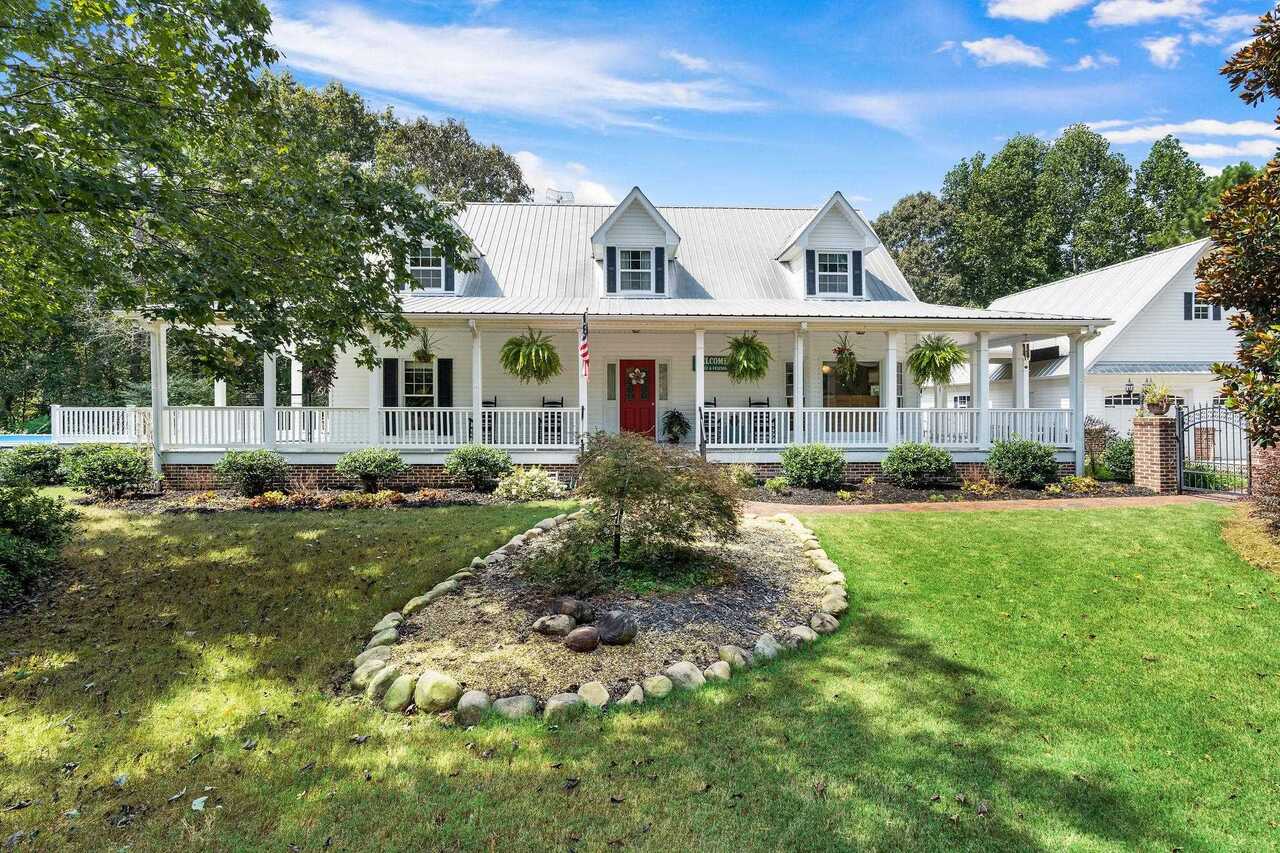True Country Living on 10 beautiful acres in highly sought after North Paulding School District. Walk up the path to beautiful brick steps and on to a porch that wraps around the entire house. Porch is all vinyl wrapped so no trim to paint. Then step inside this 6 bedroom 3.5 bath rustic cape cod beauty via the entry foyer to a focal point of a two story rock fireplace. Heartwood Pine floors throughout main level except kitchen which is tile. Separate dining features a bay window with plantation shutters to overlook the beautifully landscaped front yard as you dine. Kitchen features a nice size pantry, stone counter tops, stainless sink and oak cabinets. Master bedroom has access to porch via private door, plenty of light and a walk in closet. Master bath features separate shower and jetted tub and LVT flooring. Upstairs includes 3 bedrooms and a full bath with granite floors and a laundry shoot to the downstairs laundry room. A curved cat walk gives way to a breath taking view of the massive fireplace below and the over head windows to a beautiful view of the back of property. Travel downstairs to a finished basement featuring a living area with a gas log fireplace and built in shelving/entertainment center, two bedrooms and a full bath with a ceramic floor and an unfinished storage area with a boat door that opens to the back yard. Outside is a nature lovers paradise including an above ground pool (new pump), a playset for children, a covered patio and a fenced in area for your pets or children to roam. Beautiful landscaping and fruit trees including grapes, pears, apples and figs. A drip line irrigation system helps with watering when it is dry. A 50X50 protected garden spot with sprinklers. The two car detached garage holds a bounty of storage space with permanent stairs to attic and two solid rows of shelving. Metal 20x22 shop/garage/storage with power and a garage door is attached to back of garage. Here you could park another vehicle or work on your toys. You will also find a 18x36 shed with power for your RV or Camper. Metal roof only 11 years old. Too much to list with this custom built well loved home. Wildlife abounds!