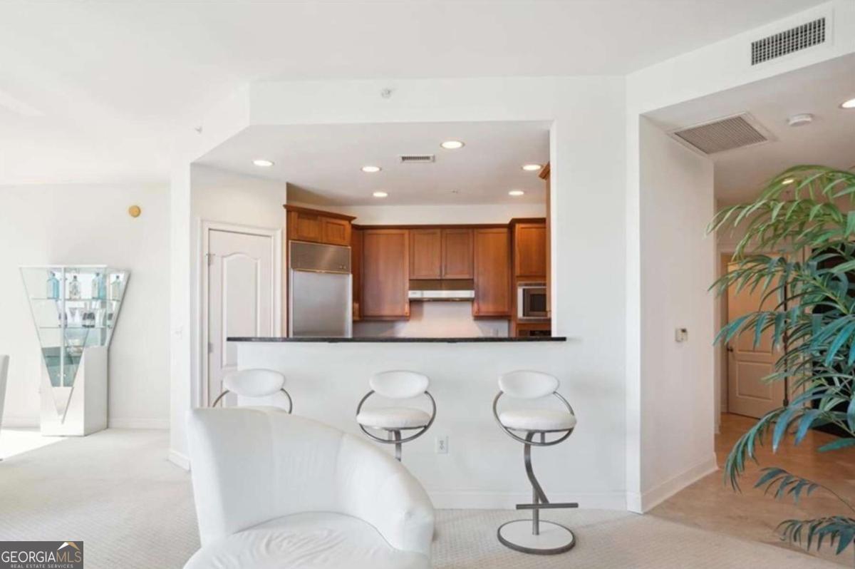 Welcome to Unit #2002 at 2828 Peachtree RD NW, a luxurious 2-bedroom, 2-bathroom high-rise corner unit condominium, located in the heart of Buckhead. High ceilings and tile flooring greet you as you enter the foyer area of this well-maintained condominium. Perched on the 20th floor, this stunning residence offers breathtaking panoramic views of the Atlanta skyline and lush Buckhead greenery through windows that flood the open-concept living space with natural light. The gourmet kitchen features sleek granite countertops, a Sub-Zero refrigerator, stainless steel appliances, and ample cabinet space, perfect for both casual dining and entertaining. The primary suite serves as a serene retreat with a convenient in-room closet, walk-in closet, and a luxurious en-suite bathroom complete with a double vanity, soaking tub, and separate glass-enclosed shower. Step out onto your private balcony to enjoy your morning coffee or unwind with a glass of wine while taking in the sunset over the city. On July 4th you need only look down from your private balcony to view the Peachtree Road Race, the largest 10k race in the world! As a resident of 2828 Peachtree, you will have access to premium amenities, including a state-ofthe-art fitness center, resort-style pool, 24-hour concierge service, and a clubroom deal for hosting events. Situated in the heart of Buckhead, you are minutes away from world-class shopping & fine dining at Buckhead Plaza and Lenox Square Mall, easy access to the Marta train system, and only 17 miles from Hartsfield Jackson International Airport. This exceptional pet-friendly property combines upscale living with the convenience of a prime location. Schedule your private showing today!