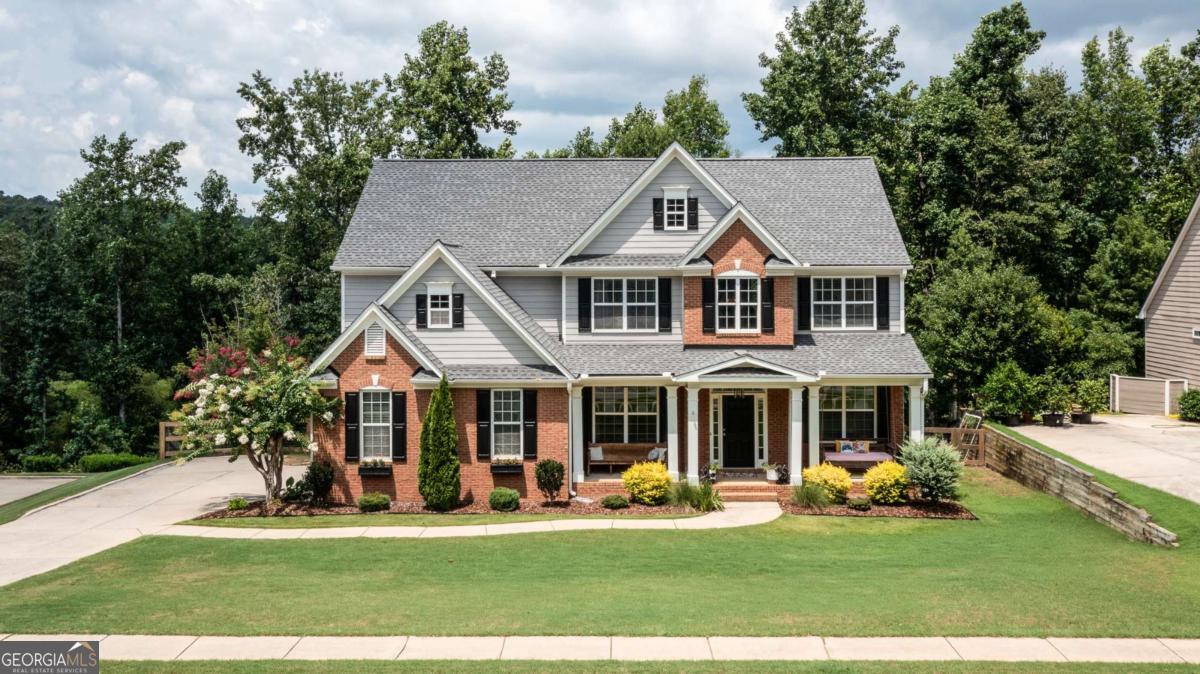 Welcome to this beautifully maintained 6-bedroom, 4 full bathroom home nestled in sought-after North Forsyth. Featuring hardwood floors throughout the main level, this home offers a warm and inviting layout perfect for everyday living and entertaining. The main level boasts a full bedroom with an adjoining full bath - ideal for guests or multi-generational living. You'll also find a separate formal dining room and a dedicated home office or study, offering flexible space for work or hosting. The heart of the home is the open-concept kitchen, complete with granite countertops, an eat-in breakfast area, and a seamless flow into the spacious living room featuring a cozy fireplace and a built-in coffee bar. Upstairs, retreat to your oversized master suite - a true sanctuary with its own fireplace and space to unwind. The luxurious master bathroom includes double vanities, a separate shower, and a soaking tub. The convenient upstairs laundry room is located right off the master suite. The fully finished terrace level includes an additional bedroom and full bath, plus a game area and secondary living space - perfect for a media room, playroom, or guest suite. Step outside to enjoy your morning coffee or quiet evenings in the privacy of your screened-in porch, overlooking a peaceful backyard. Located just minutes from Publix, dining, and easy access to GA-400, this home is also part of the highly acclaimed Forsyth County school district - consistently ranked among the best in Georgia. Don't miss this opportunity to make this stunning and spacious home your own!