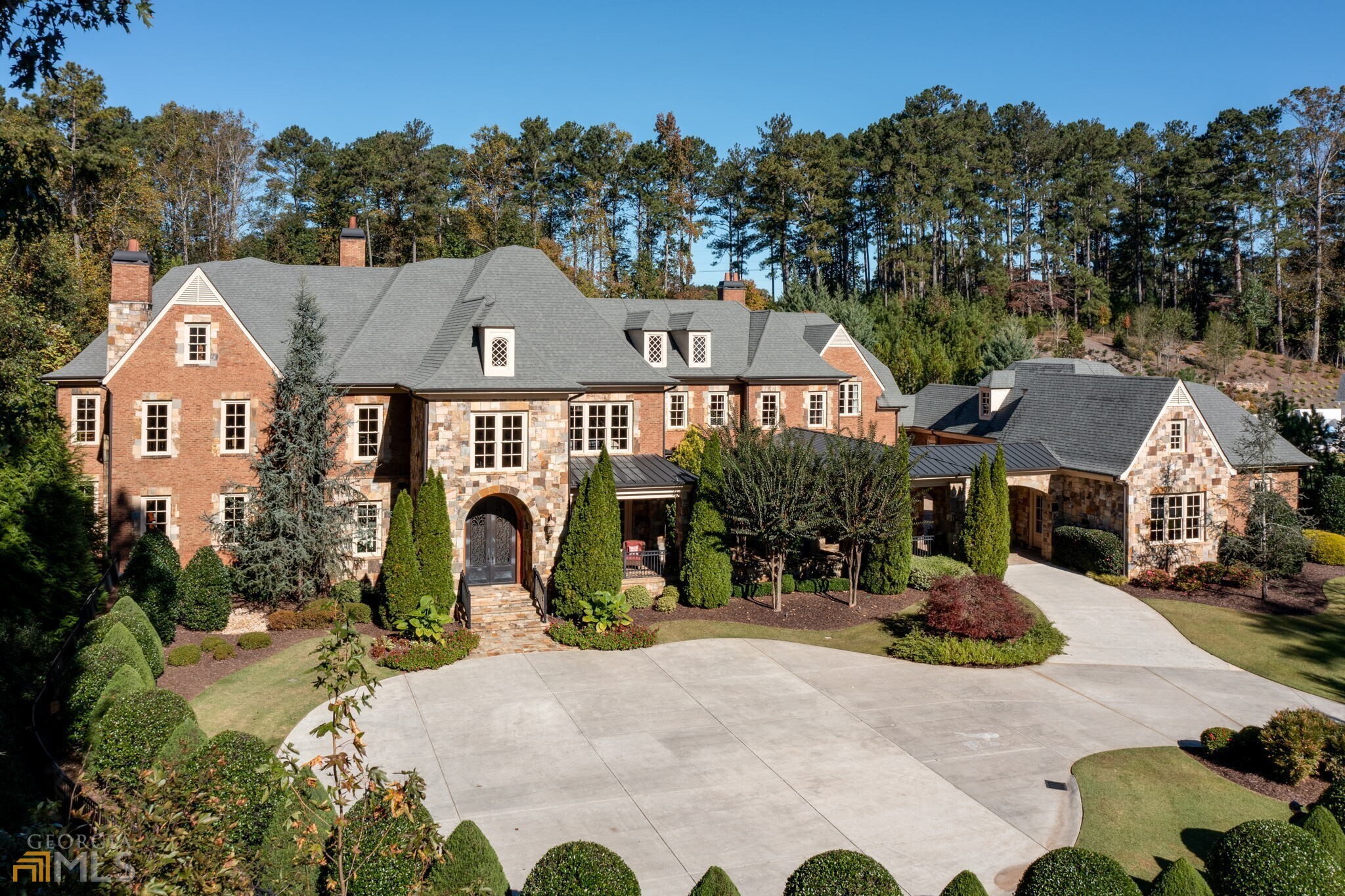 This is an opportunity to own one of AtlantaCOs most prestigious masterpiece estate homes. Glenayre is an exclusive gated and guarded community just 15 minutes north of Buckhead. Located in a private cul-de-sac on 3.66 manicured acres. This stately mansion features four sides brick and stone with abundant architectural details. Circular driveway and porte cochere lead into a paver lined motor court with access to six garages plus a full mechanic's workshop. The interior features three full levels of custom living space with extensive upgrades and plenty of luxury living space. Breathtaking two story foyer with an open circular staircase. Dramatic two story library/office with custom bookcase, fireplace, rear spiral staircase and elevator. Banquet size dining room. Two story formal living room with fireplace. Chef's kitchen with commercial grade appliances, butler pantry with custom cabinetry and built-in desk overlooking breakfast room, two story family room with fireplace and a wall of windows with views of the amazing pool and manicured backyard. Luxury master on the main with ALL the bells and whistles. Large laundry room with custom cabinetry. Second floor boasts four master suites plus a one bedroom au pair apartment complete with gourmet kitchen, and second laundry room. The finished terrace level offers a theater, billiard room, gorgeous bar, gym, sauna, fireplace and one and a half baths. Walk out from the main level into paradise! This beautiful area features a stone and brick lanai with built-in kitchen, fireplace, T&G ceiling, saltwater Pebble Tec pool with hot-tub, waterfall. Too much to list a must see for your most discerning buyer!