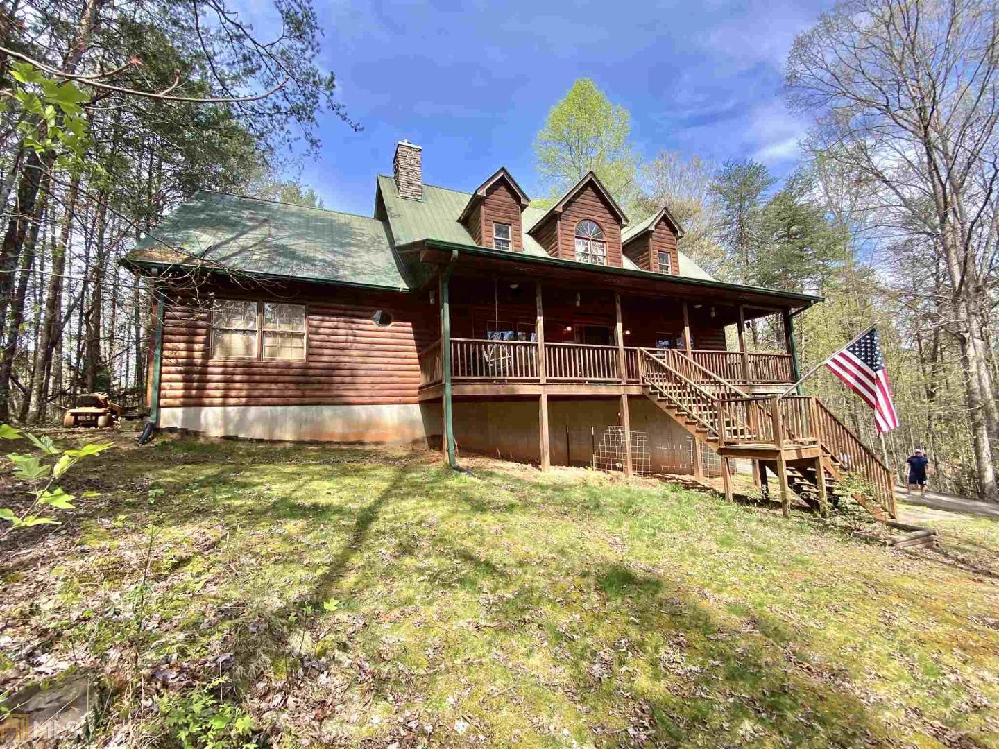 Exceptional log home with tons of square footage on over 2 private acres. 3 bedrooms, 2 bathrooms plus a huge upstairs area with potential for more bedrooms or whatever you desire. Large master is on the main with double closets and jacuzzi tub along with the other two bedrooms and a large living room with cozy wood heater, dining area, breakfast bar and open kitchen with new appliances. Partially finished basement currently used as a home gym and a pool room. The unfinished part of the basement has a boat door and plenty of storage for mowers, boat, 4-wheelers or vehicle. Perfect front porch for rocking chairs to sit and relax and take in the large open yard and all nature that surrounds. Convenient to town with privacy and seclusion. From 75S Take Joe Black Rd to Asbestos Rd, left on Mauldin Rd then another left on Albert Reid Rd and go 1.2 miles.
