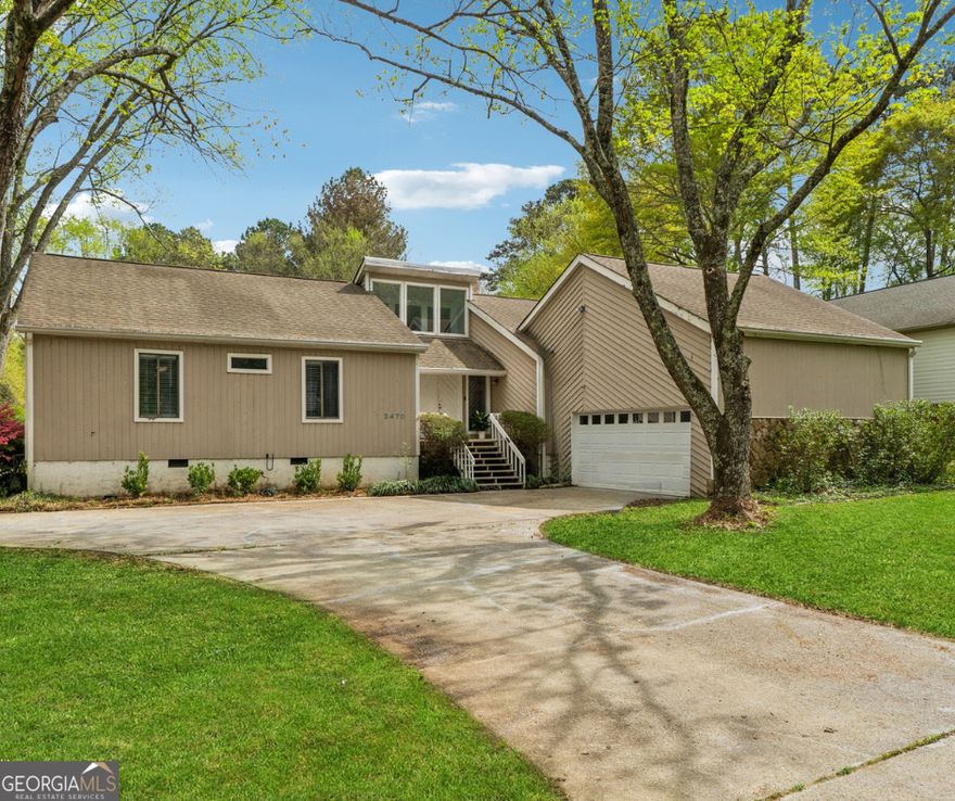 Now is the perfect time to make your next move. This charming raised ranch style home presents the perfect opportunity for you to move into your ideal space. Sweetly nestled in the established Weatherstone community on a large corner lot (just shy of 1 acre). Double wood doors welcome you home to a relaxed and serene atmosphere. Inside the main living space you will find a traditional oversized stone masonry fireplace, vaulted ceilings and built in shelving. Entrance from the garage leads to the laundry room/half bath, as well as a spacious kitchen with stainless appliances, built-in microwave, hooded gas stove top, an 'eat in' area with a large 'picture' window that overlooks the yard. Additional features include separate dining room, wet bar, and three sliding doors that are strategically placed allowing for unobstructed views of the backyard and easy access to the expansive covered deck. Leveled backyard is your very own private 'playground' and personal oasis complete with a detached shed (wired for electricity). The owners' suite is a haven for rest and relaxation with its own sliding door that gives private access to the deck. The ensuite is complete with double vanity, soaking tub, separate shower, bidet, and a skylight to top it all off. Two secondary bedrooms are just across the hall, separated by a full bath with ample storage, white cabinets and granite countertops. One of the bedrooms has a 'cozy' loft that's ideal for curling up with a good book, or simply indulging in some 'me time'. Top rated east Marietta schools. Swim/ tennis/racquetball community. Perfectly located~ less than 5 minutes to Terrell Mill Park, and Sewell Mill Park. Very short drive to Townsend Trail, Sope Creek Paper Mills Ruins, Cochran Shoals Trail. Minutes to i-75/285, Truist Park/The Battery, Marietta Square.