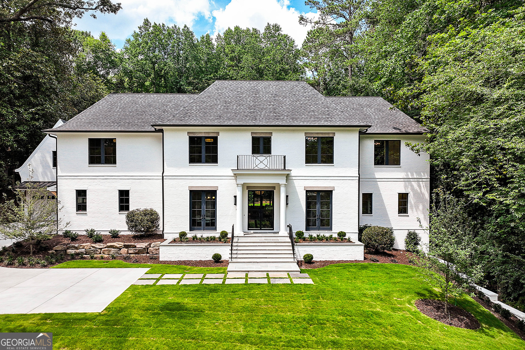 Built by LIbi Custom Homes, this showstopping home melds effortless style with time-honored architecture. Sited along a picturesque, tree-lined drive, enter through the steel-and-glass entry to discover airy living vistas superbly envisioned by Harrison Design, meticulously crafted for both grand events and everyday comforts. Organic aesthetics, housewarming hearths and gorgeous use of light create a breathtaking canvas for both alluring coved ceilings and modern moldings, while luminous fixtures, posh hardware, wide-plank floors and eight bathrooms decked in luxury add glamor and grace. Delivering you between floors, fittings for a future elevator partner with stairways leading to rooms of limitless possibilities. Turn the upper-level flex spaces into a gym or a creative haven, while on the lower level, imagine build-outs for play, film screenings, perfecting golf swings and displaying favorite wines. The home's centerpiece, the combination kitchen, living and casual dining area, enjoys a sense of expanse from the wall-to-wall windows lining the rear of the house. The professional-grade kitchen offers floor-to-ceiling cabinetry, an oversized island with seating and high-end stainless and integrated appliances. Let the chef serve soirees from the adjacent catering kitchen or prep meals outside at the grilling station overlooking the level, private outdoor sanctuary. Here, summer parties and late-night gatherings are made memorable using the refreshing pool with a convenient pool bath nearby, a fireplace-warmed, covered bluestone patio and a perfect-for-play green space. A grand yet tranquil escape, the five bedrooms feature walk-in closets and en suite accommodations that soothe. On the main floor, the primary retreat boasts artful ceilings, dual dressing rooms, and a serene bathroom comprised of separate water closets, an oversized shower and a freestanding bathtub. While touring, visit the mudroom entry, au pair-perfect, upper-level guest suite and a set of two-car garages. Then note the premium amenities, including an electric car charging station, home comfort system, security and more. Though tucked away on a quiet Buckhead street lined with blissfully secluded lots, this impressive home is convenient to shops, dining, grocery stores, excellent public and private schools, I-75 and all the perks of city living.