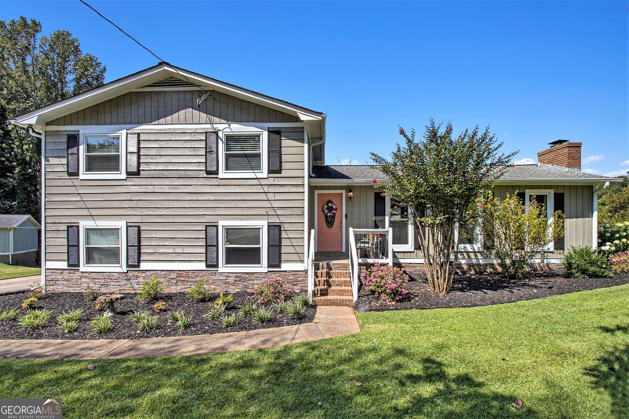 Charming Split Level on a Cul-de-Sac in Acworth! Just minutes from KSU, Shopping, Award-Winning Restaurants, and Interstates 75/575. Curb Appeal shines with a Grassy Front Yard, Gorgeous Landscaping, and Summer-Blooming Crepe Myrtles. Step inside to find Dark Hardwood Floors and an Open Main Level featuring a Brick Fireside Living Room. The Dining Area is perfectly placed by sun-filled windows, while the Kitchen offers a Large Breakfast Bar, Stone Countertops, Butcher Block Counter on the Island, Classic Subway Tile Backsplash, and White Cabinets. A Vaulted Ceiling Sunroom adds flexible living space ideal for a Home Office, Playroom, or cozy Sitting Room. Enjoy morning coffee here or step out to the Private Screened-In Porch, perfect for Al Fresco Dining overlooking the Large Fenced Backyard. Upstairs, the Primary Bedroom boasts an Updated Ensuite with a Stone Vanity and Oversized Glass Shower. Two Additional Bedrooms share a Hall Bath with a Tub/Shower Combo. The Backyard is a True Paradise Flat and Fully Fenced with plenty of room for Play, Gardening, and Entertaining, plus year-round enjoyment on the Screened-In Porch. A 15-Foot Blueberry Bush, which produced over 50 lbs. of blueberries this year, is the centerpiece of the garden and a true delight for nature lovers. Additional highlights include a Two-Car Garage with Workbench included, offering storage and workspace for hobbies, projects, or organization. Nestled in a Quiet, Charming Community, this home offers unbeatable access to Kennesaw, Woodstock, Acworth, Cartersville, and East Cobb. Minutes from Lake Allatoona and the peaceful Clark Lake, you'll enjoy Tranquil Views and Lake Life just around the corner. With a Prime Location near the Cobb County line, you'll have the Best of Both Worlds convenient to both Cobb and Cherokee Counties while tucked away from busy roads in the tight-knit Cherokee South neighborhood. Don't miss your chance to call this Acworth treasure your next home!