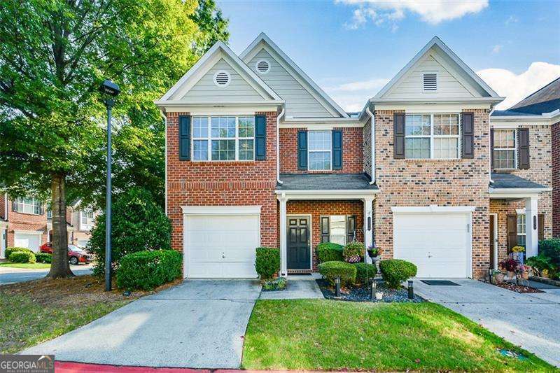 Welcome home to this bright end-unit townhome that backs up to community green space. Overflow parking is also steps away. The location of this unit within the beautiful, gated Heritage Park Community is ideal! The main level has a beautiful foyer entry opening up to a great room with a fireplace, dining area, and plenty of windows and natural light. The kitchen has updated granite, stainless steel appliances, and a stylish backsplash. The upstairs laundry is handy, between the two upstairs bedrooms. The primary bathroom was recently renovated to include a large luxury shower. Buyers will love the huge walk-in closets in both bedrooms. The en-suite bedrooms create an ideal roommate floor plan. Recent upgrades include Epoxy flooring in the garage, new water heater, dishwasher, garbage disposal and kitchen lighting. Conveniently located close to 75, 575, and KSU. This townhome provides a unique opportunity for both comfort and accessibility!