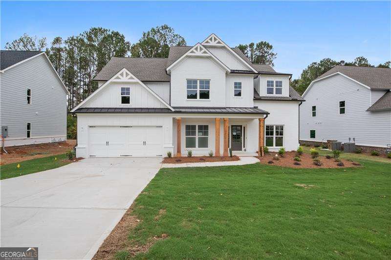 Explore the impressive Garrison Craftsman-style floor plan featuring 5 bedrooms and 4 baths. The home welcomes you with formal living and dining rooms that seamlessly flow into the kitchen, highlighted by a spacious island. The breakfast area offers a delightful view of the private backyard from the covered deck that overlooks beautiful Powers Lake. Inside, you'll find white shaker cabinets, a double oven appliance package, and elegant quartz countertops. The main living areas feature gleaming hardwood floors, adding a touch of luxury to the space. On the main level, there's an office or bedroom along with a full bath for added convenience. Upstairs, you'll discover the spacious master suite, a bedroom with its own private bath, and two generously sized bedrooms that share a bathroom. The large lot provides privacy and best part there are no HOA fees! Beautiful Enclave of 4 homes tucked away on private drive. RELAX ON YOUR COVERED DECK WITH AMAZING VIEW ON POWERS LAKE. A DREAM COME TRUE FOR THOSE WHO WANT A QUITE AND PRIVATE BACKYARD!!!