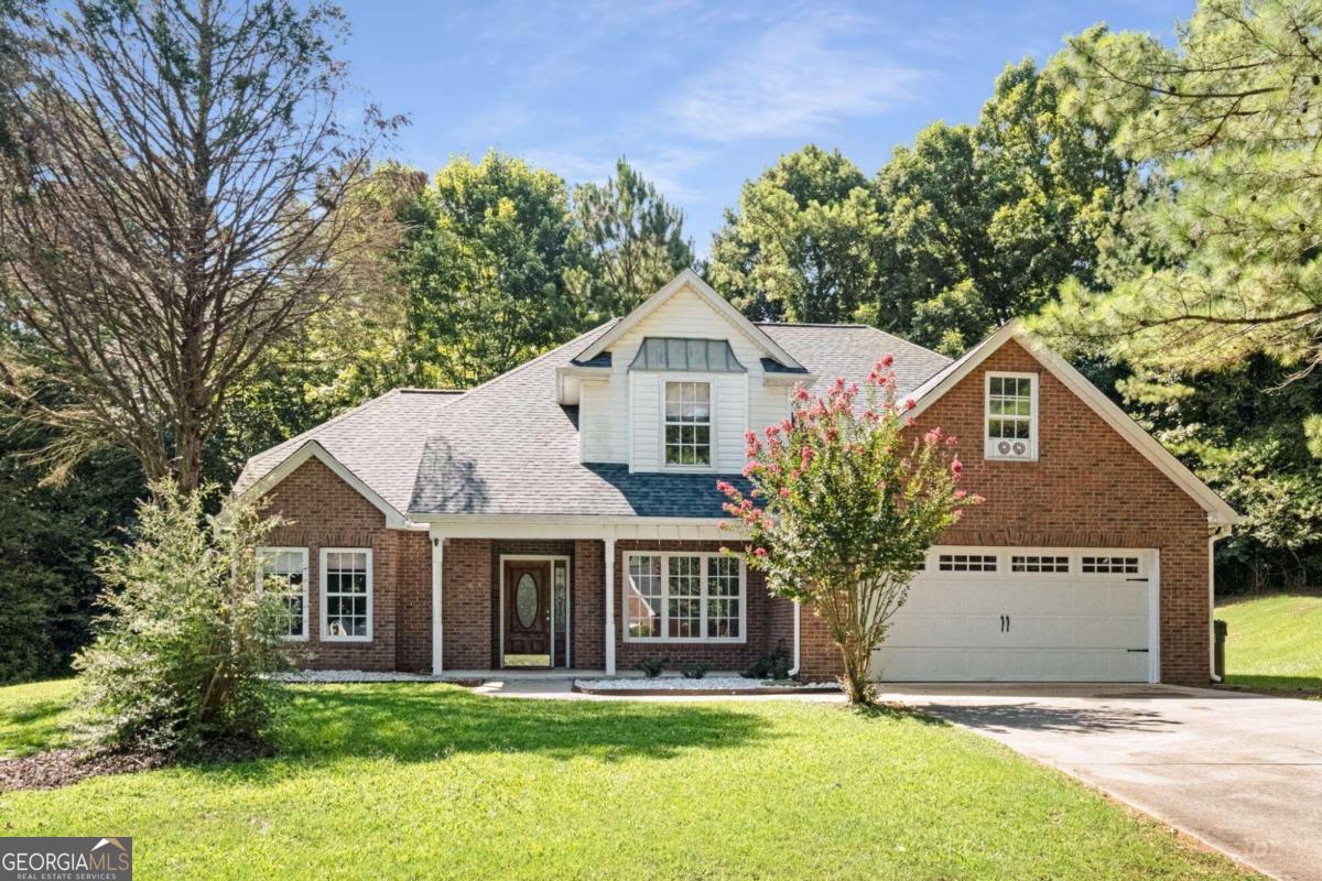 SELLER IS OFFERING A NEW FALL BREAK INCENTIVE: Increasing from $5k to $10k for buyer to use towards anything they want! Welcome to this stunning, completely renovated 5 bedroom home situated on a spacious 3/4 acre lot in a charming cul-de-sac. The entry foyer greets you and leads into a vaulted great room with a two-sided fireplace, seamlessly connecting the living room and dining area. The great room boasts a two-story wall of windows, providing abundant natural light and offering picturesque views of the private, wooded lot.    An additional separate room on the main floor is versatile and can serve as a separate dining room, home office, family room, or playroom. The newly renovated kitchen is a chef's delight, featuring granite countertops, stainless steel appliances, a breakfast bar, and a walk-in pantry.  The expansive primary suite located on the main floor is a true retreat. It features a tray ceiling, two walk-in closets for ample storage, and a spa-like primary bath with a tiled, separate shower and a soaking tub.  All bathrooms have been updated with tiled floors and new vanities, ensuring modern comfort and style. The upper level features four generously sized bedrooms.  This home has been completely updated with new systems and even features solar panels for maximum efficiency and reduced utility costs!    This home's prime location offers exceptional convenience. It is approximately 3.5 miles from I-20, providing an easy commute, and about 25 miles from Atlanta Airport. The property is also close to shopping, including The Mall at Stonecrest, as well as a variety of restaurants and more. Schedule your tour today!
