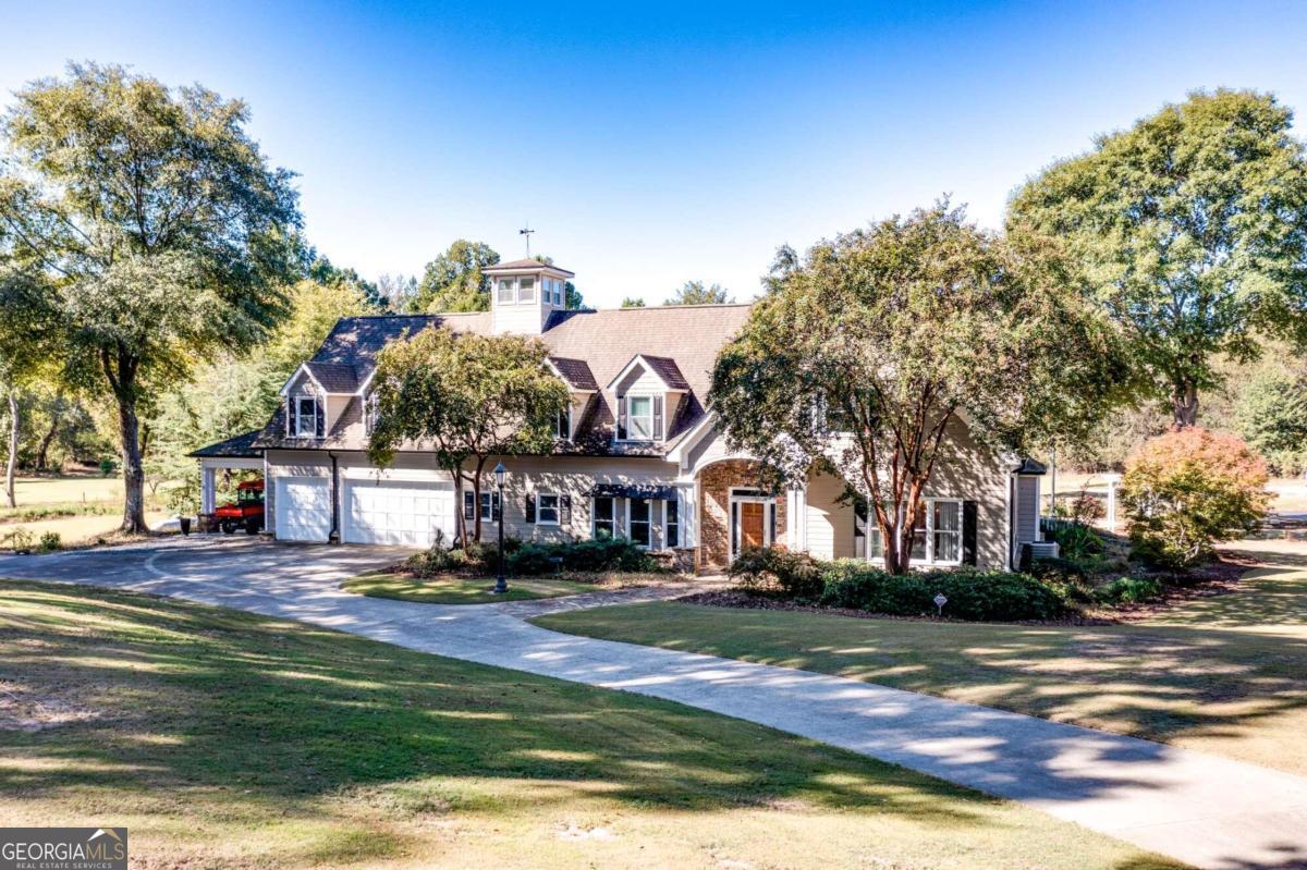 Welcome to your own private oasis nestled in the heart of Jackson County! This stunning 20-acre estate boasts unparalleled privacy and luxury, offering a lifestyle of tranquility and convenience. As you enter through the gated deep entry, youll be greeted by stone-lighted columns and a Bluetooth keypad for added security. The paved, sealed driveway stretches 1200 feet, leading you to your retreat away from the hustle and bustle of city life. This magnificent home features 5 bedrooms, including one on the main level, and 4 baths, providing ample space for family and guests. The great room and dining room offer elegant spaces for entertaining, while the foyer exudes warmth and sophistication. Prepare culinary delights in the gourmet kitchen, equipped with modern appliances and ample storage space. Upstairs, the owners suite has a spacious vaulted ceiling and all the conveniences one expects in a luxury home. The laundry room adds convenience to daily life along with three more bedrooms and two baths. The third floor lookout is the perfect place to enjoy a four sided view of the property. Outside the large rear covered porch invites you to relax and enjoy the peaceful surroundings. The property also includes a separate one-bedroom, one-bath building ideal for in-laws or a home office, complete with storage and a living room. Car enthusiasts will delight in the oversized 3-car garage which can actually hold up to 6 cars, as well as outbuildings perfect for business use or a car collection. In addition to the huge garage there is a modern steel equipment building providing additional space and features a 100 amp electric panel and paved driveway making it perfect for RVs, boats, and all your other vehicles. Nature lovers will appreciate the mature trees and plantings that offer privacy, including pecan, oak, and Japanese maple trees. A spring-fed pond stocked with fish and a chase area with a fire ring provide opportunities for outdoor recreation, while arrowheads found on the property add a touch of history and intrigue. For those with a green thumb, the estate offers fruit trees, gardens, and a nursery house, as well as space for additional buildings. Two soccer fields and additional pastures provide plenty of room for outdoor activities, while a 300-yard driving range is sure to please golf enthusiasts. Conveniently located just 4 miles off I-85, this property offers easy access to nearby amenities and is only an hour from Hartsfield Airport and 45 minutes from Athens, GA. Whether youre seeking a peaceful retreat or a place to build your dream home, this estate offers endless possibilities for luxury living in a picturesque setting. Additionally, there is potential to develop the property with up to 13 estate lots or rezone for additional subdivision lots. Call today to setup your private tour.