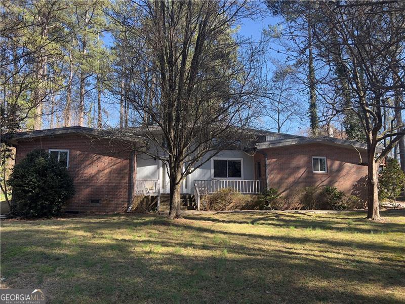 If you are an investor looking for a great opportunity, or a buyer looking to get ahead with some sweat equity, come and see this 4 sided brick fixer-upper located in East Cobb. This 3 bedroom, 2 bath home is situated in the perfect location, just minutes from shopping and dining, and easy interstate access. This home sits secluded from the world, while also being surrounded by $1M+ homes. Some of the notable features include the beautiful 4 sides brick, the updated vinyl windows, and the side entry garage. There is also a separate detached full size 2-car garage, perfect for a shop or additional parking for that collector car. Not too many opportunities for homes in the price point in East Cobb, so don't miss your chance to grab this one while you still can.