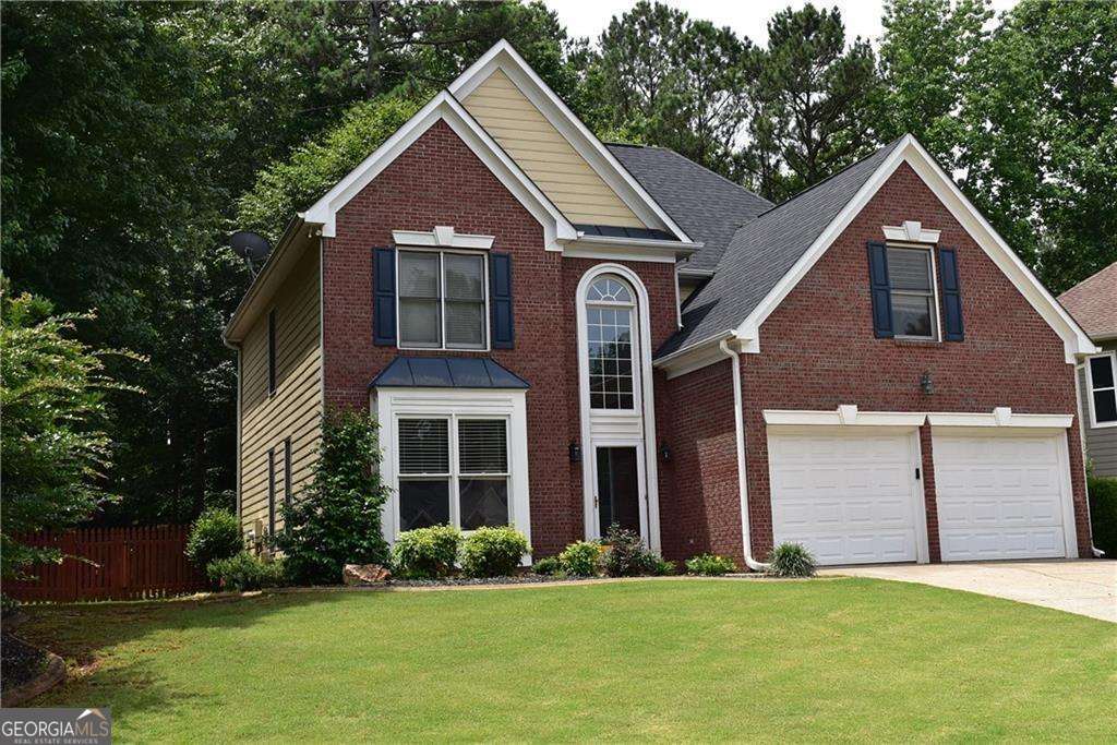 Wonderful home in popular Towne Lake community. NEW PHOTOS COMING SOON. Final touches being done for this move in ready home with fresh paint (updated photos coming - ignore these paint colors) newer carpet on main, hardwood floors upstairs. All new stainless appliances in the kitchen plus granite counters, breakfast area with view to family room and wonderful sunroom. Private wooded fenced backyard. Large master and three additional bedrooms up with two full baths. Great amenities, walk to pool, nearby shopping, restaurants, schools and golf.
