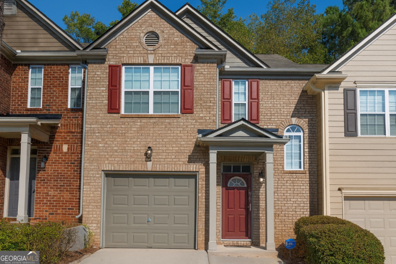 This MOVE-IN ready property is located in a beautiful, well-maintained and quiet gated community minutes from I-20 and I-285. A 2-story, 1,635sq ft townhouse with 3 bedrooms, 2.5 bathrooms, a 1 car-garage and a private 2-car driveway in front of the house. Brand new HVAC systems with furnaces and a brand new Hot Water Heater. House is wired for Fiber, a security system, cable, newly painted with storm doors at the front and garage doors. First floor, cozy living room with fireplace and remote control ceiling fan/lights perfect for relaxing or entertaining. Large dining room with wainscoting. Crown molding throughout the first floor. Hardwood floors covering large galley kitchen with ample cabinets, gas stove, side-by-side refrigerator, dishwasher, and pantry with breakfast bar seating. Coat/indoor storage closet. Large powder room and foyer entrance with hardwood floors. Patio with attached storage and black iron fence for privacy. Second floor: Oversized master bedroom with hardwood floors and ceiling fan, and a large walk-in closet. The ensuite bathroom includes dual sinks, plenty of lighting, and ample space for your daily routine with a separate garden tub and shower. Two additional large bedrooms, full hallway bathroom and full size washer and dryer included in the laundry closet. Community & Amenities: the HOA maintains landscaping and manicures shrubbery add elegance to your surrounding. Enjoy the community swimming pool and playground for easy living. Security gates at bothfront and rear entrances provide peace of mind. This home offers the ideal lifestyle yu've been seeking, with conventional, VA, or cash financing options available. Sold AS-IS.
