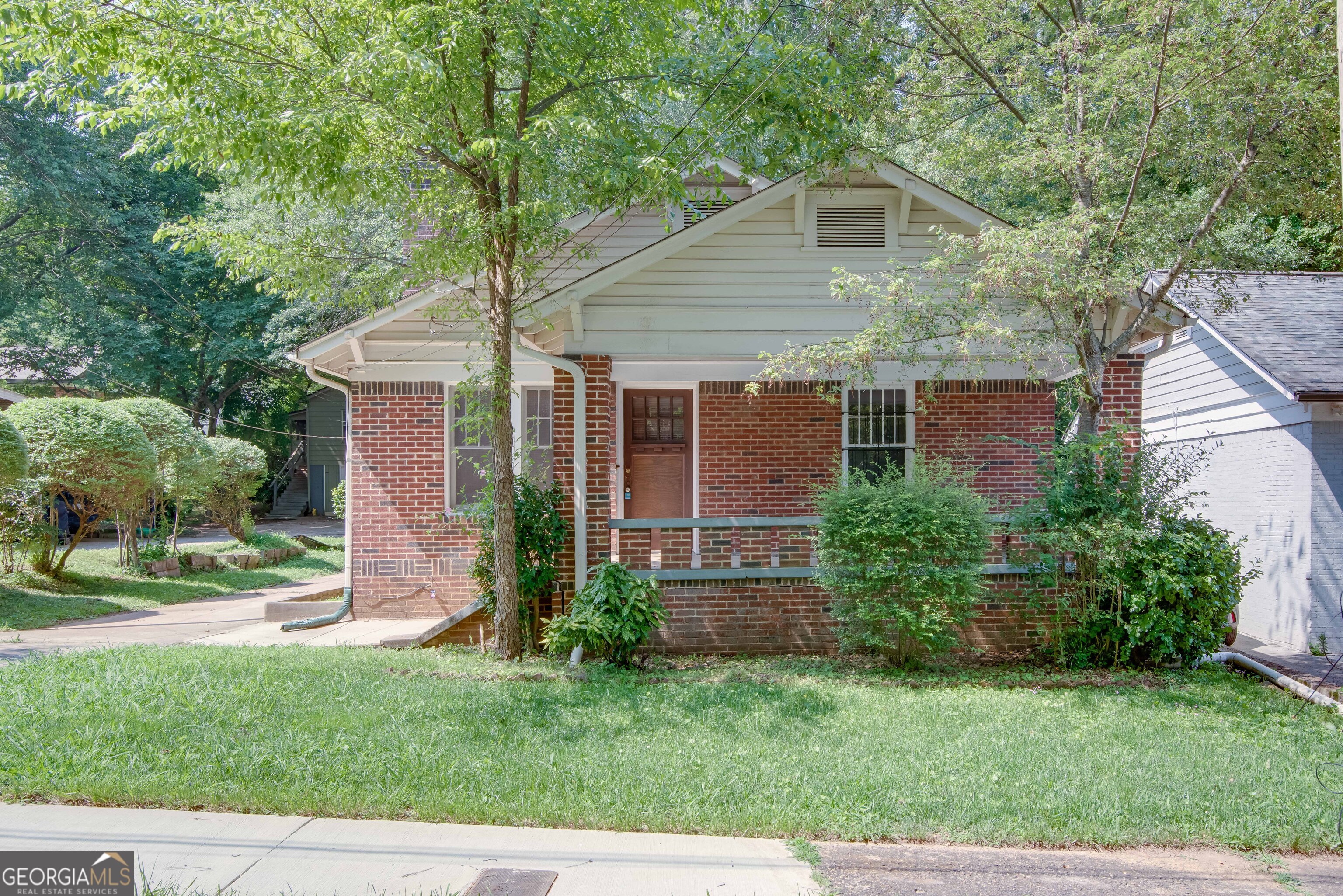 Adorable brick bungalow with detached 1 car garage. Welcome home to a wonderful home located in East Point. This is a three bedroom one bath home with hardwoods throughout. Separate living room and dining room. Eat in kitchen and separate laundry room. Rocking chair covered front porch. Located close to airport, all major Atlanta hwys, Delta, Porsche and Tyler Perry Studios. This home is not approved for vouchers.