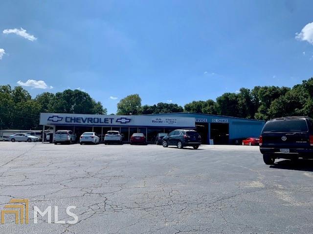 OLD MOORE CHEVROLET -on VETERANS PARKWAY  located on MAIN STATE HWY 41, Yatesville Rd & close prox to Hwy 36, Forsyth ByPass & minutes to dwtn BARNESVILLE.  Perfect location for dealership or other opportunities but the value in the land. 11.68 ACRES to build whatever you like; hotel, grocery store, business district. Several buildings on property.  Fronts on Hwy 41 (Veterans Pky) and Yatesville Road.  Appx 900' frontage on Veterans and 311' on Yatesville Rd.  ENDLESS POSSIBILITIES for Commercial Use