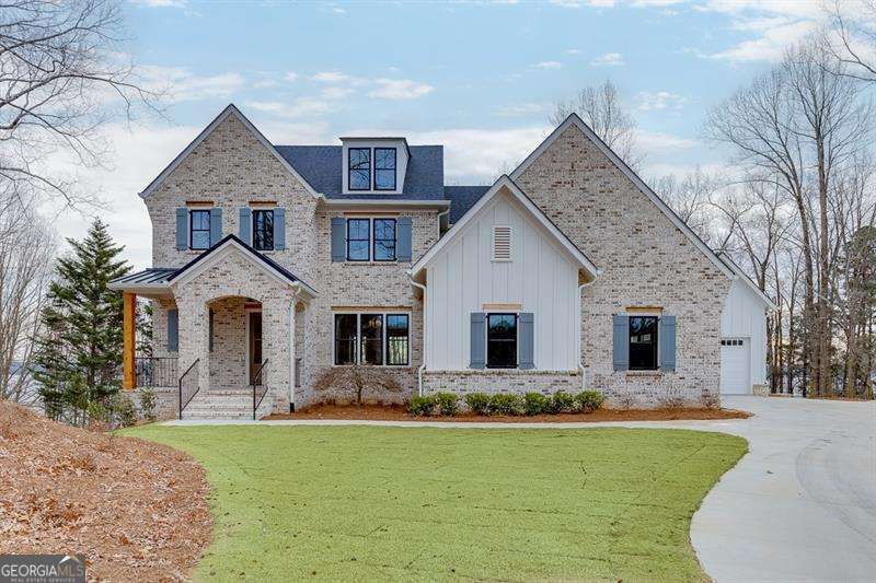 Welcome to 7625 Breeze Bay Road, an exquisite modern farmhouse offering an unparalleled lakeside lifestyle on the picturesque banks of Lake Lanier, Cumming, GA. This newly constructed single-family residence boasts four spacious bedrooms and 4.5 elegant bathrooms, providing ample space for comfort and privacy. Nestled on a generous .58-acre lot, this stunning home greets you with a charming front porch that invites relaxation amidst the serene natural ambiance of Lake Lanier. The interior dazzles with an open-concept design that emphasizes space, light, and luxury. Soaring ceilings and expansive windows create an airy retreat that is both inviting and grand. At the heart of the home lies a sophisticated living area, seamlessly connected to a gourmet kitchen equipped with top-of-the-line stainless steel appliances, a sprawling island, and custom cabinetry. The main-level primary suite offers a tranquil escape, featuring a spa-like bathroom and a walk-in closet, all set against the backdrop of breathtaking lake vistas. The lower level of the home is primed for entertainment and personalization, with ample space for future customization to fit your leisurely pursuits. Outside, the allure of lakeside living continues with a covered brick rear porch, complete with a cozy fireplace, and private access to your dock and beachfrontCoperfect for boating, swimming, or simply unwinding under the stars. Finished with premium hardwood flooring and chic designer elements, every inch of this home exudes a sense of refined elegance. A three-car garage adds to the convenience and exclusivity of this property. Take advantage of a rare opportunity to own a piece of paradise on the prestigious Lake Lanier.