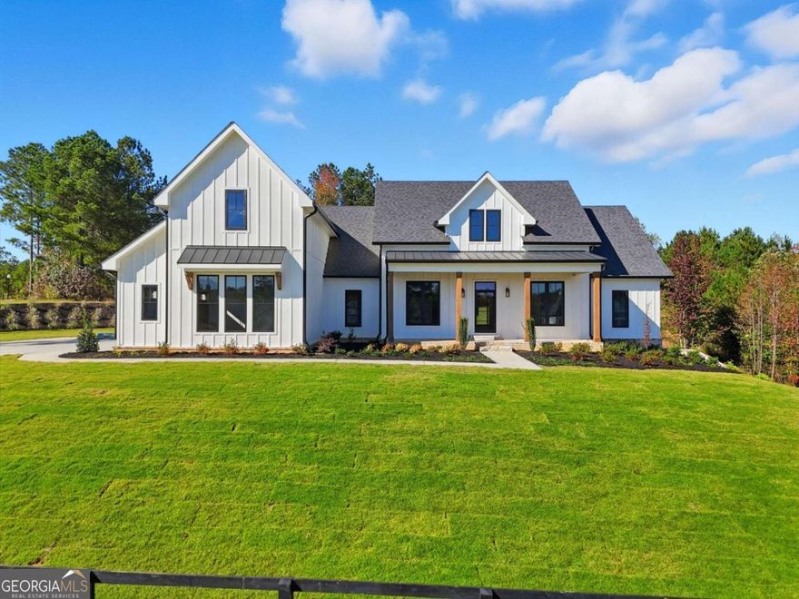 NEW CONSTRUCTION! Modern Farmhouse Retreat on Over 4.5 Acres. Welcome to this stunning ranch-style modern farmhouse, where luxury meets craftsmanship on more than 4.5 acres of serene countryside. Spanning over 3,300 square feet, this beautifully designed 4-bedroom home offers a seamless blend of elegance, functionality, and high-end finishes throughout. As you arrive, you're greeted by striking curb appeal and a spacious 3-car garage featuring custom teak wood doors. Step inside to soaring volume ceilings, exquisite trim work, and thoughtfully selected decorative fixtures that make every room feel elevated. The open floor plan flows effortlessly, anchored by a chef's kitchen equipped with high-end appliances, a built-in wine cooler, quartzite and marble countertops, and custom cabinetry throughout. The primary suite is a true retreat with spa-inspired finishes, custom tile work, and an incredible walk-in closet outfitted with premium shelving. Additional features include a massive bonus room with its own bath-perfect for a home office, gym, or guest suite-and a full walkout basement offering limitless potential. Entertain with ease on the covered rear porch, or enjoy immersive sound from the app-controlled surround system. Other luxury upgrades include commercial-grade windows and doors, hardwood flooring, tankless water heater, spray foam attic insulation, and hardwired security cameras. Absolutely no detail has been overlooked-nothing is builder grade. Experience modern farmhouse living at its finest-privacy, space, and unmatched quality-all just minutes from town.