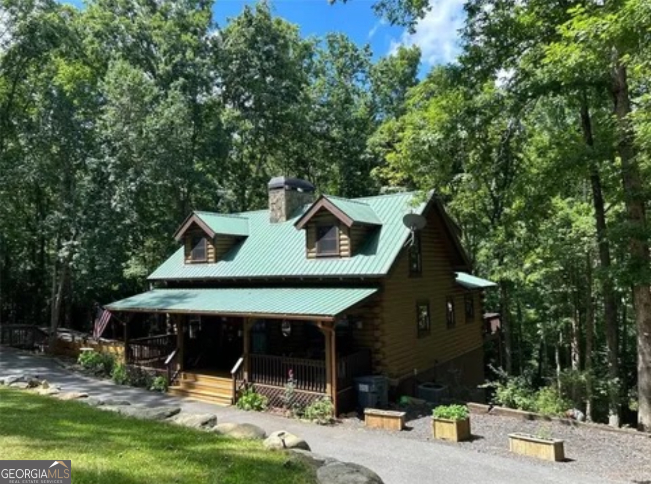 A private 5+ acre gem minutes from GA 400 and the central shopping/outlet mall/growth of Dawsonville!