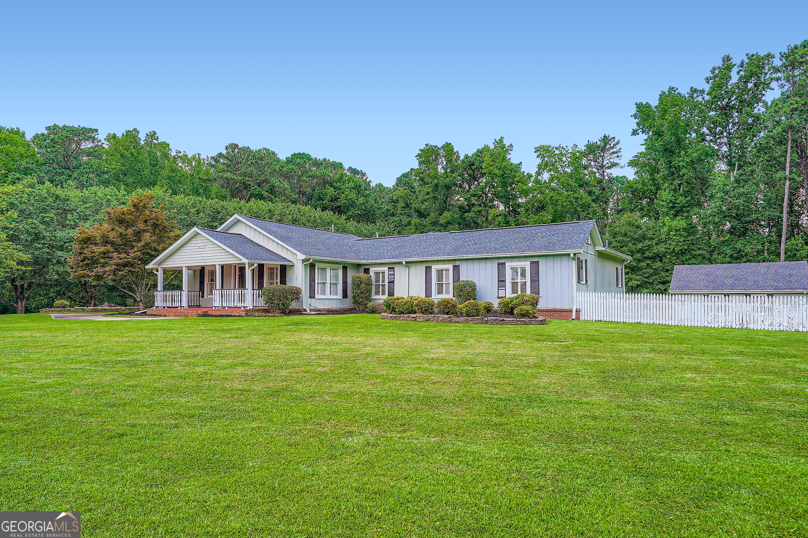 Charming 3-bedroom, 2-bath home situated on 3 pristine acres in the highly desirable Harrison High School District. This well-cared-for property offers timeless character with solid hardwood floors throughout, oversized bedrooms, and a spacious primary suite featuring a walk-in cedar closet and a large bath with separate tub and shower. The updated kitchen includes granite countertops, abundant cabinetry, and updated stainless steel appliances (2024), including a gas stove, dishwasher, and built-in microwave. Enjoy meals in the formal dining room with a bay window and custom built-in storage. Outside, the property offers a peaceful retreat with open green space, mature trees, and plenty of room for gardening, recreation, or future enhancements. A barn and two separate garages provide excellent storage, workshop space, or hobby potential. Newer HVAC (2021) adds peace of mind. This home is move-in ready with solid bones and offers an incredible opportunity for buyers to further update or personalize over time. Listed below appraised value-don't miss this rare chance to own acreage, privacy, and potential in an unbeatable location!