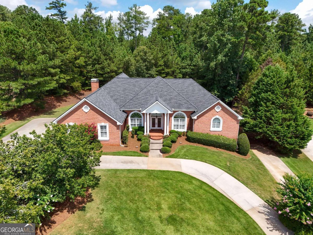 Stunning All-Brick Home in Prestigious St. Remy Subdivision - 4 Beds 4.5 Baths Partially Finished Basement Gunite Saltwater Pool Welcome to this exquisite 4-bedroom, 4.5-bathroom all-brick home located in the highly sought-after St. Remy subdivision. This elegant residence showcases exceptional finishes and thoughtful design throughout, including crown molding, rich tile and wood flooring, and a spacious full basement. Step through the leaded glass French doors into a grand entrance and beautiful receiving area that sets the tone for the rest of the home. Just off the foyer, you'll find a versatile office or sitting room complete with its own full bath-perfect for guests or working from home. The formal living room is both spacious and inviting, featuring a stone-tiled hearth fireplace with gas logs and serene views of the stunning pool area. The heart of the home-the kitchen-offers an oversized island, walk-in pantry, plentiful cabinet and counter space, and a conveniently located half bath, with walk-out to back deck. The massive owner's suite is a true retreat, complete with tray ceiling, a peaceful sitting area overlooking the pool, and direct access to the wraparound deck. Enjoy dual walk-in closets, a luxurious spa-style en suite with double vanities, a tile and glass shower with dual shower heads, and a deep soaking tub. Secondary bedrooms are generously sized with large closets and share a well-appointed Jack-and-Jill bathroom. The large laundry room includes a sink, cabinetry, and folding counters for convenience. Downstairs, the partially finished basement boasts laminate wood flooring, four finished rooms ideal for recreation, hobbies, or guests, and a custom wet bar-perfect for entertaining. Four sets of doors lead directly to the show-stopping backyard. Outdoors, you'll find a private oasis: a Gunite saltwater pool with a hot tub and cascading waterfall, surrounded by stately brick walls and an iron gate for privacy. The expansive covered back deck wraps around the home and provides a protected area for outdoor dining, grilling, or relaxing-even in inclement weather. Additional features include a whole-house central vacuum system and a Rain Bird irrigation system, making maintenance easy and efficient. 3-car garage with multiple parking spaces on primary driveway and circular driveway. This one-of-a-kind home offers space, luxury, and timeless appeal-don't miss the opportunity to make it yours!