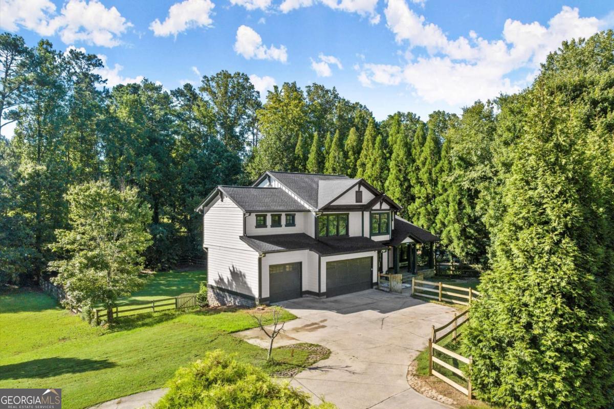 Tired of the same old, same old, cookie cutter home? Then this thoughtfully updated executive-style residence is what your family's been craving...Sophistication, Comfort, and Freedom! Located in the East Cobb school district and designed with both elegance and functionality in mind...this home balances refined living spaces with modern upgrades at every turn. Step in off the spacious custom stone front patio into a welcoming open 2 story foyer that flows seamlessly into the open family area...featuring large family room, upgraded open kitchen (new appliances, new quartz, modern cabinets, recessed lighting and functional island), breakfast/coffee nook, and eating area. The living room and dining room flow off the kitchen...creating a perfect layout for entertaining and everyday living. A dedicated office, remodeled half bath, impressive wood deck and 3-car garage wrap up the main level. Upstairs, discover an ample amount of space with a large landing area, four bedrooms and three full baths, including a luxurious custom primary suite with a sitting area, fully renovated bathroom (you're going to love this...have you ever experienced a copper tub?), and customized closet. Three spacious secondary bedrooms feature updated baths and plush comfort with one being a large guest or teen suite w/ full bathroom. The upgraded 1400 square foot basement reveals custom finishes throughout with a large entertainment area (TVs, custom bar with bar stools, sink, frig, and tasteful custom trim and paint), a bonus room (5th bedroom or theater room), nice unfinished area for storage, craft/workshop room, and yet another full bath. Additionally you'll find access to the covered water proof stone patio, large fenced open backyard with a stone walkway to front of house. Extra features include solid wood doors throughout, updated lighting throughout, irrigation system, Epoxied garage floor, and new attic foam insulation. From the elegant finishes and thoughtful upgrades, to the large private lot, this home is ready to welcome its next owners with style, security, and plenty of room to live, work, and play.