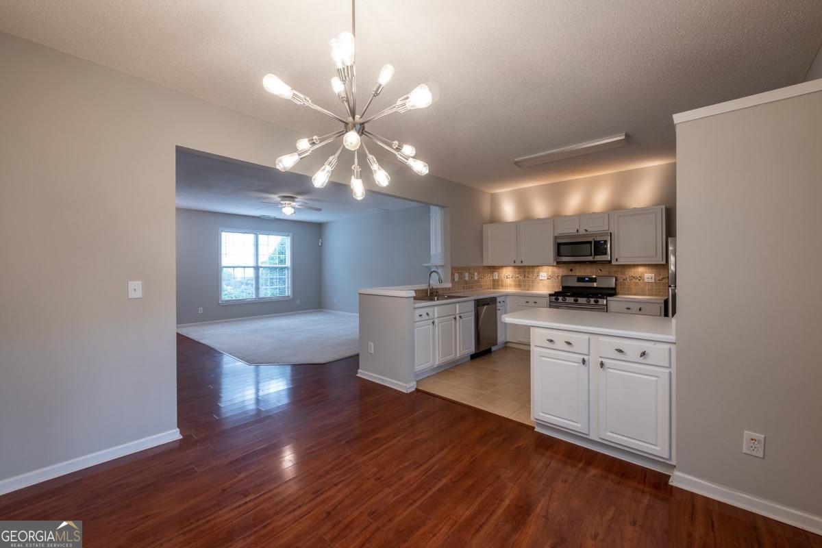 Welcome to 4084 Howell Park Road, a beautiful 3-bedroom, 2.5-bath townhome in the heart of Duluth, GA. Just minutes from the vibrant Downtown Duluth Town Green, you'll enjoy festivals, concerts, and year-round community events. At the same time, nearby McDaniel Farm Park and Shorty Howell Park offer trails, picnic spots, and wide-open green spaces. Global dining, shopping, and cultural hotspots line Pleasant Hill Road, with H Mart, Jeju Sauna & Spa, and the Gas South District all within easy reach. Commuters will love quick access to I-85 and Ride Gwinnett connections to Doraville MARTA. Inside, this home blends elegance and comfort with an open floor plan, wood and tile flooring, and a cozy tile-wrapped fireplace as the centerpiece of the living area. The gourmet kitchen features stainless steel appliances, a custom stone backsplash, and cabinet lighting above and below, creating both beauty and practicality. Upstairs, the spacious primary suite features a custom-built-in closet and a granite bath, while two additional bedrooms offer flexibility for guests or a home office. Thoughtful details, such as elegant lighting, ample storage, a full laundry room with washer and dryer, and a private patio, complete the space. Residents enjoy more than just a place to live. All Sovereign Realty & Management residents are enrolled in the Resident Benefits Package (RBP) for $35.00/month, which includes liability insurance, credit building to help boost residents' credit scores with timely rent payments, our best-in-class resident rewards program, on-demand pest control, and more. More details upon application. From its stylish finishes to its unbeatable location, this home makes every day feel like an upgrade.