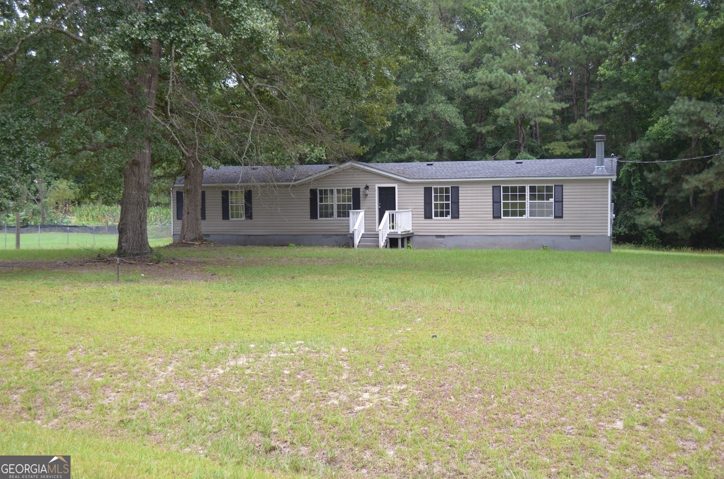 Move in ready and affordable home checks a lot of boxes. Spacious 3 bed/2 bath manufactured home w/ retired title on level +/- 1.1 Acre lot. LVP and new carpet throughout. Kitchen with island and granite counters opens to Dining Rm and Den w/ fireplace. Living room adds second area for kids to call their own. Large Master Bdrm with walk-in closet and en-suite. Carport and shed provide extra storage spaces. Covered porch provides a nice retreat or outdoor eating area. Convenient and country-like peaceful location. Come see today!