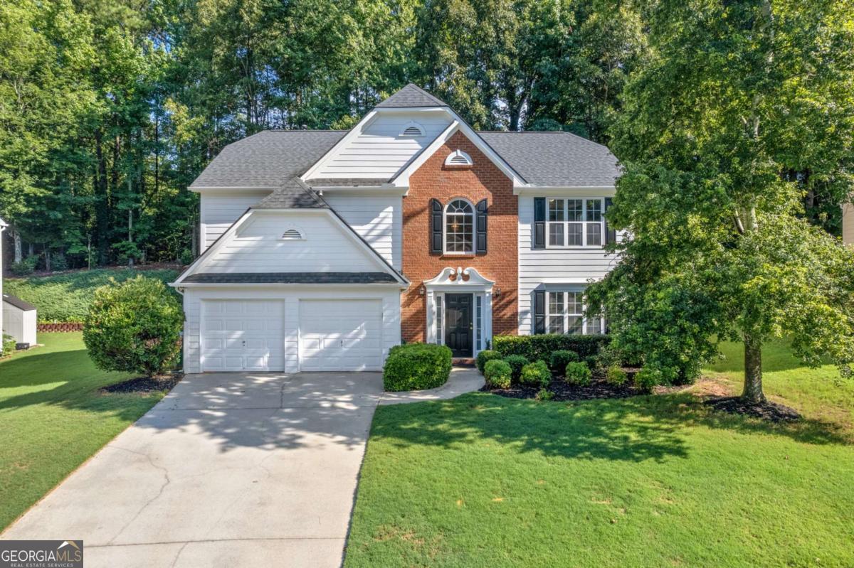 Discover this stunning 3-bed, 2.5-bath two-story home nestled on a quiet cul-de-sac in the amenity-rich community of Ashwood Grove in the award winning Brookwood Schools district! Surrounded by mature landscaping, this home features soaring ceilings, abundant natural light, and charming architectural details throughout. The open-concept layout boasts a formal living area, a formal dining area, and a convenient half bath. The impressive two-story great room showcases a brick fireplace and a wall of windows overlooking the wooded backyard. The custom kitchen features stainless steel appliances, a gas range, a breakfast bar, and a butler's pantry. Upstairs, the primary retreat offers a tray ceiling, spa-like bath, and walk-in closet. Two spacious secondary bedrooms share a full bath. Enjoy outdoor living with a central deck and expansive open-air patio, not to mention the lush green front lawn! Updates include roof (2019), HVAC (2022), and water heater (2020). New carpet, paint and flooring throughout make this home Move in Ready! This home has been so well taken care by it's original owner and would be the perfect lifestyle home for your Client! Close to the community pool (walking distance) shopping, dining, and entertainment! Discounted rate options and no lender fee future refinancing may be available for qualified buyers of this home