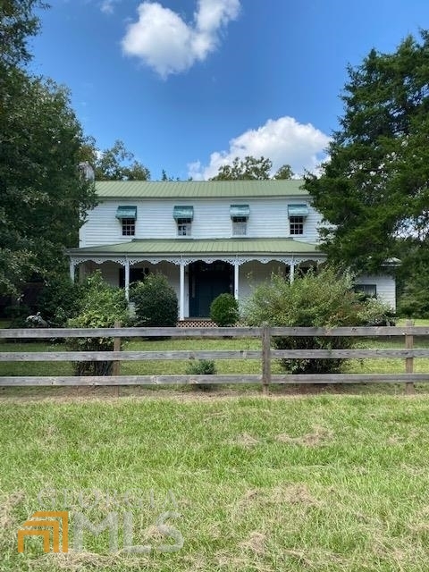 LEASE PURCHASE this beautiful piece of BIG BUCK LAND. Hunters pay attention ! Owners will do a SHORT TERM lease purchase NOW on this beautiful piece of property with hunting rights included and will be able to close the sale the end of May 2023. Included in the SALE is a CIRCA 1920's Historic two story house (Needs TLC) with newer metal roof, a huge front porch, outbuilding, a private well AND SIGNIFICANT TIMBER VALUE. Large spring fed creek with gorgeous creek HARDWOOD bottoms. Owners are licensed real estate brokers/agents in the state of GA.