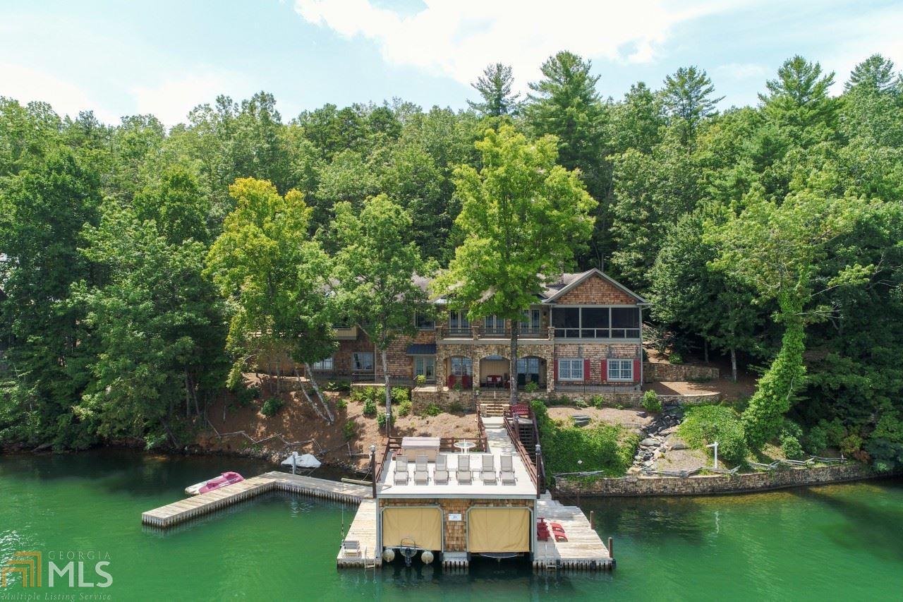 "Grandview" 6/7 BR 4.5 BA Luxury lodge style retreat; 1 acre lot off paved Laurel Lodge Rd/224' lake frontage/Deep water/25' waterfall/SW lake side w/million dollar views/Gorgeous handcrafted kitchen/ 2 master BRs/ Laundry room w/pantry, 2nd partial kitchen, 2 dramatic foyers/30x12 patio/24x30 screened porch, cathedral ceiling, beams, stacked stone FPL/ Breezeway to 3-4 car garage w attic; Courtyard w/ BBQ pavilion; Boathouse w hot tub on top deck/storage room/Workshop; RV parking/ Stone seawall, fabulous sunrises; Elevator/Handicap-friendly/Golf & Tennis nearby. Motivated Seller