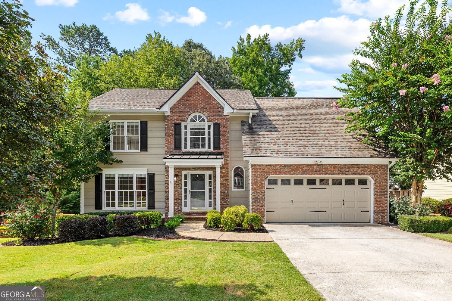 Welcome to Country Walk, a beloved community in the heart of Cobb County known for its top-rated schools, fantastic amenities, and ideal location. This beautifully maintained cul-de-sac home offers a spacious, open-concept layout perfect for everyday living and entertaining. The main level features a formal living room, separate dining room, and a welcoming kitchen with stainless steel appliances, glass-front cabinetry, a breakfast bar, and a cozy breakfast nook overlooking the backyard. A new kitchen sink and faucet add a fresh touch, while the adjacent family room impresses with vaulted ceilings, custom built-ins, a stone-accented gas fireplace, and abundant natural light from oversized windows. Step outside to the extended back deck, complete with a pergola and ceiling fan, creating the perfect setting for outdoor relaxation. The backyard is fenced and professionally landscaped, offering both beauty and functionality. Upstairs, the oversized primary suite features trey ceilings, updated paint, and room for a sitting area. The large walk-in closet has a professionally installed organization system, and the ensuite bath includes a soaking tub, separate shower, and dual vanities. Additional upstairs bedrooms are generously sized and freshly painted, with a conveniently located laundry room nearby. The finished basement expands the living space even further, offering a large recreation room, workshop, storage room, and a cedar-lined closet. One of the basement rooms could easily be converted into a bedroom, and nearby plumbing provides the potential to add a bathroom. This home has been thoughtfully upgraded over the past few years, including whole-house surge protection, a newly upgraded service panel and circuit breakers, new garage doors, a new roof, remodeled bathroom, new ceiling fans, updated flooring in the bathrooms, a new deck and fence, and a termite bond in place. Residents of Country Walk enjoy a host of community amenities including a pool, tennis courts, clubhouse, pavilion, basketball court, and playground. The Silver Comet Trail is just around the corner, and the community even offers a convenience store and gas station at its entrance. With easy access to I-20, I-285, Hartsfield-Jackson Airport, and Truist Park, this central location makes everyday living effortless. This is more than a home,it's a lifestyle in one of Cobb County's most cherished neighborhoods.