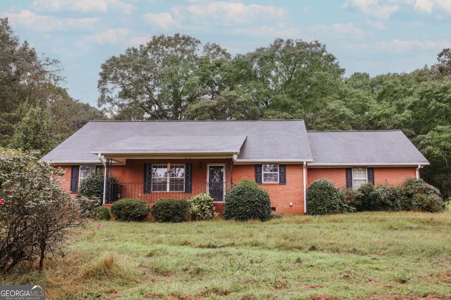 Country Living Meets Oconee Convenience! Discover your own slice of serenity with this well-maintained, classic brick ranch on a sprawling 11.27 acres in highly sought-after Oconee County, GA. Located at 2300 Colham Ferry Road, this very clean 3-bedroom, 2-bathroom home offers a traditional floor plan, ready for its next owner to infuse their personal style or enjoy its timeless charm as-is. You'll enjoy countless sunrises from the oversized covered porch and love the shade provided by the large oak trees throughout the backyard. The home has plenty of storage thanks to oversized closets, a huge laundry room, and an attached 2-car garage that includes additional storage closets. Beyond the home, the impressive acreage features a rustic barn that measures 64x36 (2304 square feet). The property also houses a peaceful pond! This property is perfect for hobby farming, recreation, or simply enjoying privacy. The location is unbeatable, offering the tranquil escape of rural life while being just minutes from the vibrant downtown Watkinsville, the exciting Wire Park mixed-use development, and an easy commute to Athens and the University of Georgia (UGA). This property is a rare find, combining space, location, and potential!