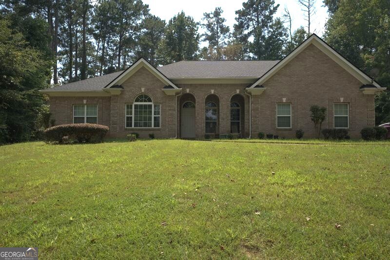 Welcome to this spacious ranch-style, four-sides brick home on a 1.1-acre lot in the rapidly growing Conyers area. Set back with a large backyard bordered by private woods, this property offers both privacy and convenience, just minutes from Route 138. Inside, the single-level floor plan features 3 bedrooms, 2.5 bathrooms, and a versatile office/den. The vaulted ceilings and open layout create an airy feel, while the screened-in patio provides a perfect space to relax and enjoy the serene views. The secondary bedrooms share a Jack-and-Jill bathroom with dual vanities, while the primary suite features new carpet and plenty of natural light. The eat-in kitchen is designed for both function and style, offering granite countertops, stainless steel appliances, and a double oven, all overlooking the backyard. A separate dining room is ideal for gatherings and entertaining. Additional highlights include a new roof (June 2025) and timeless four-sides brick construction. This property is part of an estate sale and being sold as-is. The pricing reflects cosmetic updates and repairs needed, making it a fantastic opportunity to add personal touches and value.