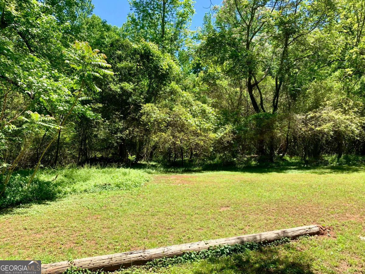 Great investment property in the city of Commerce. This 4.30 acre tract has several building sites. This tract is all wooded for privacy. It does has city water and city sewer available. Has paved road frontage. No perc test at this time.