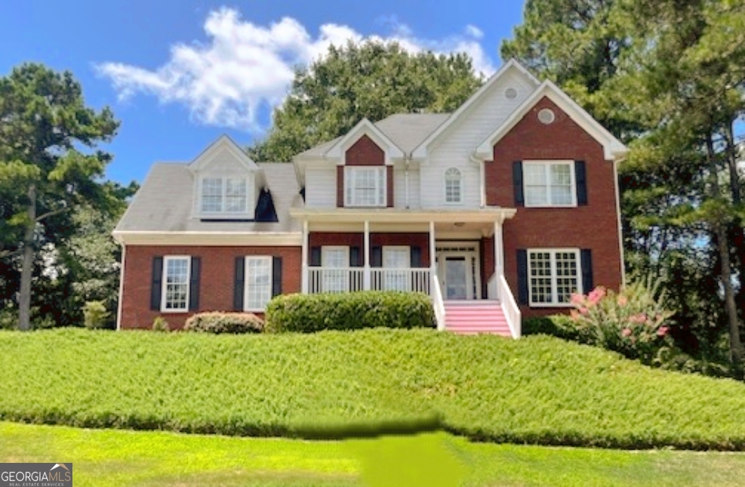 Spacious 7-Bedroom Retreat with In-Law Suite - Priced to Sell at $510,000! Welcome to 8100 Greens Mill Way - a beautifully maintained 7-bedroom, 3.5-bath home on a serene, very private, elevated 0.6-acre lot in one of Loganville's most sought-after neighborhoods. Step inside to a grand two-story foyer and gleaming hardwood floors throughout the main level. The home's expansive layout offers a formal dining room, cozy living room, and a sun-drenched family room with a charming fireplace. The heart of the home is the stunning kitchen, featuring brand-new granite countertops, ample cabinetry, a cheerful breakfast nook, and open views of the backyard oasis. Upstairs, the oversized owner's suite boasts tray ceilings, a spa-style bath with jetted tub, dual vanities, and a generous walk-in closet. Three additional bedrooms and a convenient laundry room complete the second level. The fully renovated third-floor in-law suite is a standout bonus. It offers three bedrooms, a full bath, laundry, a kitchenette, and its own private entrance-ideal for multigenerational living or rental income. Recent upgrades include new ceiling fans, water-saving toilets, fresh interior paint, a new AC unit, and more. Enjoy peaceful mornings in your backyard oasis with scenic views, or host unforgettable gatherings with plenty of entertainment space. Appliances (washer, dryer, and refrigerator) are included, and a 1-year home warranty offers peace of mind to the new owner. Don't miss this rare opportunity-schedule your private tour today before it's gone!