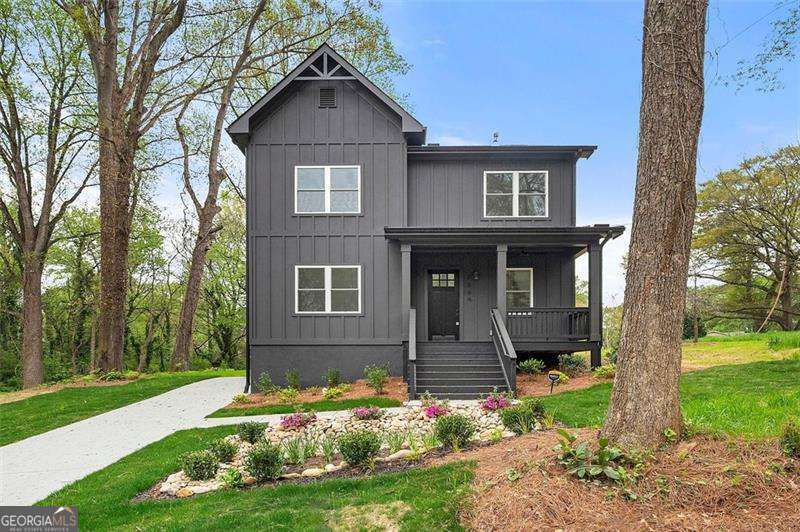 This stunning new construction home perfectly blends modern elegance and inviting charm, offering luxurious finishes, spacious open-concept living, and impeccable craftsmanship in the heart of Atlanta. From the moment you step onto the welcoming front porch and into the soaring foyer, you'll be captivated by the thoughtful design and seamless flow of the home. The expansive living room, centered around a gorgeous fireplace with backyard views, opens effortlessly to the chef's kitchen, featuring a stunning Quartz waterfall island with hidden storage, floor-to-ceiling shaker-style cabinetry, sleek granite countertops, modern fixtures, and high-end stainless steel appliances. A versatile main-level room with an en-suite bath serves as the perfect home office, playroom, or guest suite. The owner's suite is a true retreat upstairs, boasting a custom wood-paneled accent wall, a spa-like bath with a soaking tub, frameless glass shower, and an oversized walk-in closet. Additional bedrooms offer ample space for relaxation, guests, or work-from-home flexibility. Interior highlights include stunning hardwood floors, a built-in wine cooler, designer accent walls, and a modern fireplace. Step outside to enjoy the BBQ-ready outdoor space, perfect for entertaining. Ideally located just minutes from Hartsfield-Jackson Atlanta Airport, major interstates, top restaurants, shopping, parks, walking trails, and the Beltline, this home offers unparalleled convenience, style, and comfort. Don't miss the opportunity to make this exquisite new construction home yours!