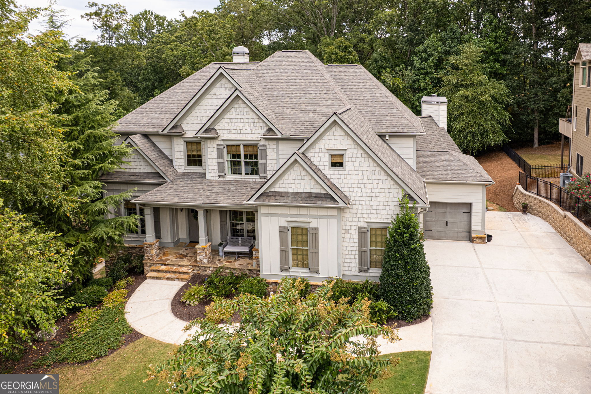 The Power Ball of Homes is hitting the market...and you can be the Jackpot Winner! Your highly desirable prize, an UPDATED and MOVE-IN READY luxury home is conveniently located in popular South Forsyth County. Enjoy EASY ACCESS to everything: retail, restaurants, TOP RATED SCHOOLS, Halcyon, The Collection, GA 400, medical, parks, entertainment, Lake Lanier and soon...Whole Foods. Walk to Stoney J's Vineyard Bistro for wood-fired pizza or scrumptious Italian dessert. Your west-facing new home is filled with SPECIAL FEATURES! Relax on one of two COVERED porches whenever you desire. The flagstone front porch provides an intimate sitting area. And the back porch is truly a FOUR SEASON retreat...just turn on the fans in the summer and the overhead heaters in the winter. Lounging, playing games, watching movies and dining al fresco have never been so delightful. Your main level is thoughtfully designed in an OPEN floorplan style with two WOOD BURNING fireplaces and an angled Keeping Room/Breakfast Room adjacent to the spacious kitchen. The current owners worked with the SEMI-CUSTOM builder, Magnolia Residential, to create an impressive and highly functional kitchen area.The OVERSIZED ISLAND comfortably seats five, includes power outlets and is crowned by high end leathered granite in timeless neutral tones. Copious amounts of additional counter space, double ovens and a GAS COOKTOP with exterior ventilation make preparing and serving meals seem almost effortless. Storage drawers and cabinets flank all sides of your gorgeous kitchen and are complemented by custom wood shelving in the large WALK-IN pantry. Conveniently tucked off to the side of the kitchen is your MUDROOM with more storage and hanging space for the entire crew. The expansive main level also features a TWO STORY foyer with a private office/flex room on the left and an inviting dining room on the right. Gleaming HARDWOODS adorn the entire main level, including the guest bedroom, which has private access to a fully updated bathroom with a modern walk-in shower. Not to be outshined by its counterparts, your casually elegant fireside Family Room effortlessly showcases magnificent views of the lush backyard and beckons you to sit back and unwind. Your upper level, with a 2024 HVAC system, features an enormous multi-purpose media room that can also serve as a home school, teen gathering space, second family room or even a playroom. Your graciously appointed primary suite is entered through double doors and features a sitting area overlooking the grassy & wooded backyard. Updated in 2022, your MODERN PRIMARY BATH incorporates sophisticated tile, a beautiful stand alone soaking tub with a handheld rinsing fixture and a spa-style shower that spoils even the most product-loving connoisseur with four storage niches, designer shower head with another handheld rinsing fixture and a bench. Your light-filled walk in closet has the perfect amount of space, plus it has hidden storage for off-season items or hiding gifts. A generously sized and light-filled ENSUITE bedroom also boasts a walk-in closet. Two additional bedrooms share a very spacious jack & jill bathroom with double vanities. Your DAYLIGHT terrace level is currently used for storage and working out. Stubbed for a full bath, it's ready for customizing to fit your specific wants and needs. A large WALKOUT PATIO, beautiful hosta garden and a lush lawn provide excellent space for kids of all ages. It's also POOL READY with ample green space to spare. On top of ALL of this (no pun intended), a BRAND NEW ROOF with 50 year shingles was installed in July! Hold onto your hat bc there's MORE...the Gables has a community pool and a recently RENOVATED clubhouse that residents can reserve twice a year for free...what an unexpected PERK! Yes indeed, THIS ONE IS THE JACKPOT. Showings start on Friday, schedule yours now!