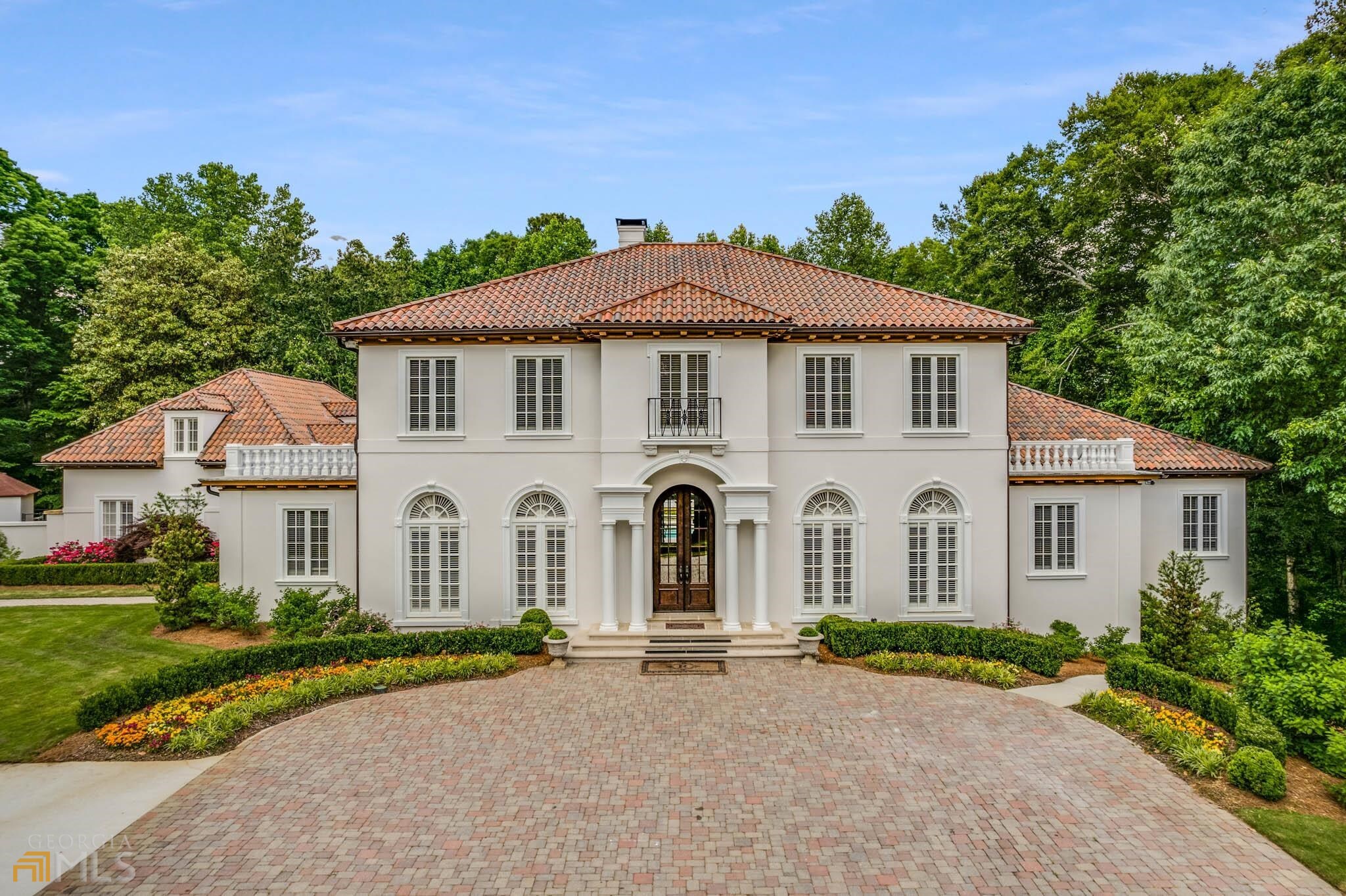 Executive gated estate on over 2 private acres of lush landscaping. Offering quiet seclusion while being just minutes away from private schools, parks, shopping and interstates. Atlanta address without City of Atlanta taxes. Recently remodeled kitchen with marble countertops and top of the line appliances. Freshly painted exterior and secondary bathrooms were updated May 2022. Master on the main and massive closets. Fully finished basement with oversized gym, would also make a great media room. Security system including surveillance monitoring. No lack of storage. Gated entry, whole house generator, au-pair or guest suite with separate private entrance. Covered patio across rear of property and pool house. Large motor court and oversized 4 car garage. Not a single amenity missing with this estate and it's move in ready!