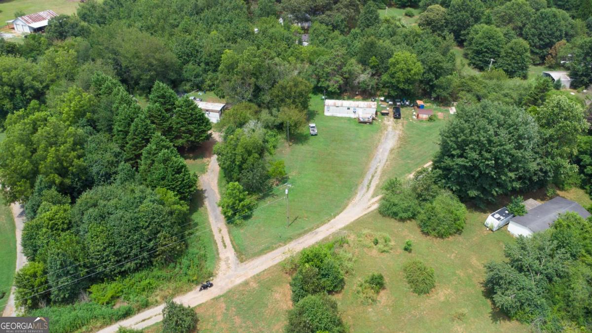 Single wide mobile home with one acre of buildable land. Cross reference FMLS # 7619881. This particular property is part of a larger listing (fmls 7619881) that listings currently consist of 2 acres and 2 mobile homes. Both are currently leased. Will divide. Beautiful land to build your future home on while you occupy the mobile home or keep for investment property. 5719 Parks Rd is a 3 bedroom 2 bathroom home built in 1980 and is approximately 924 sq ft. (per tax records). 5707 Parks Rd is a 2 bedroom 1 bath home built in 1993 and is approximately 644 sq ft. (per tax records).