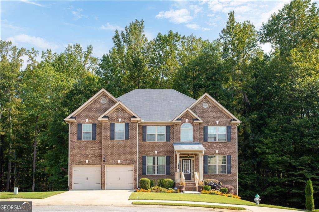 Tucked away in a cul-de-sac, this brick-front traditional home gives you the space you've been craving, the layout that makes everyday life easier, and the low-maintenance, move-in-ready condition that lets you start living on day one. Step inside to a true foyer with a dedicated office greeting you at the front of the home with french doors, great light, and real separation from the household buzz. The heart of the home stretches across the back: an open family room with fireplace to gather and get comfortable, a casual eat-in area that overlooks the back deck and a kitchen designed for real life. The 9ft island is the command center; morning coffee, homework, snacks, and game-day spreads all work here. Tons of cabinets, generous countertop space, and a walk-in pantry keep everything tidy and accessible. Prefer a sit-down meal? The separate dining room is ready for birthdays and holiday dinners without moving furniture around. And a full guest bedroom and bath on the main level offers flexibility for visitors, multigenerational living or a playroom. Upstairs, the private bedroom level keeps daily routines organized with a central laundry room and ample closets. The standout is the extra-large primary suite with its own bonus sitting room that is ideal as a quiet retreat at the end of the day, a second office, or a quiet lounge. The spacious primary en-suite includes a large walk-in closet and a well-appointed bath with 2 large separate vanities and a shower and separate soaking tub. With 4 additional rooms upstairs aside from the primary suite there is enough space for everyone. Downstairs, the walk-out basement is already underway and what I like to call semi-finished; multiple open rooms for gym, studio, or media space plus an existing fully finished bathroom and enough room to add more bedrooms. Outside, the cul-de-sac setting means minimal traffic for playing and safe bike riding and gives privacy, while the deck and gentle lawn make weekend grilling easy. Brick frontage, newer flooring, and neutral finishes equal low maintenance and low stress. And living in Fairburn adds even more. Enjoy the Third Fridays Concert Series, the Fairburn Exchange & Farmers Market with live music, gardening tips, and even a mobile petting zoo, plus the annual Fall Festival and annual Tree Lighting which are community traditions and can become your family traditions. Nearby Duncan Park offers a pool, splash pad, walking trails, basketball courts, baseball fields, greenspace, and playgrounds for an active, outdoorsy lifestyle. Room for everyone. Spaces that work. A welcoming community. 627 Stream Ct is ready when you are.
