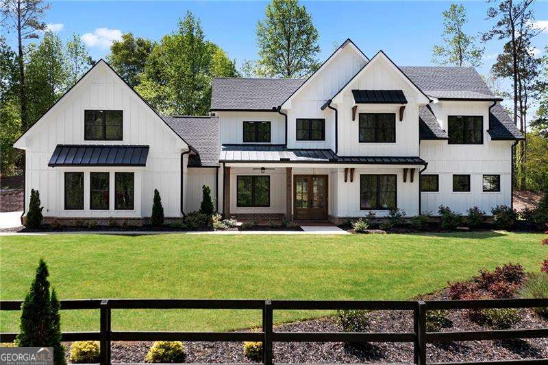 Welcome to your dream farmhouse nestled in the desirable Farm Gate subdivision of Woodstock! This extraordinary 7-bedroom, 6-bathroom estate sits on a generous 1.38 acres! Step inside to discover an inviting open-concept layout that combines a touch of modern and a touch of charm. The heart of the home features a spacious living area that flows seamlessly into a beautiful kitchen, with a large eating room. The kitchen also features a large walk-in pantry, upgraded cabinets with inserts, exotic quartz countertops, island farmhouse apron sink, upgraded Zline appliance package including: dishwasher, 36" gas stove with 36" vent hood, microwave drawer, and refrigerator. The home has an open modern floor plan with vaulted ceilings in the kitchen, dining and sunroom. Access to a private patio from the living and dining. Primary suite with spa-like bathroom, huge walk-in shower with Kohler shower system and free standing tub, his and her closets and generous laundry. Natural lighting throughout, giving the home a very open feel. For car enthusiasts, the expansive 3-car garage offers plenty of space for vehicles and storage. Above the garage is a large finished flex space for office, gym or private suite with a full bathroom. Situated in a peaceful neighborhood known for its privacy and picturesque surroundings, this property combines the best of both worlds-country living with easy access to local amenities. Don't miss out on this exceptional opportunity to own a stunning farmhouse that embodies luxury and comfort!