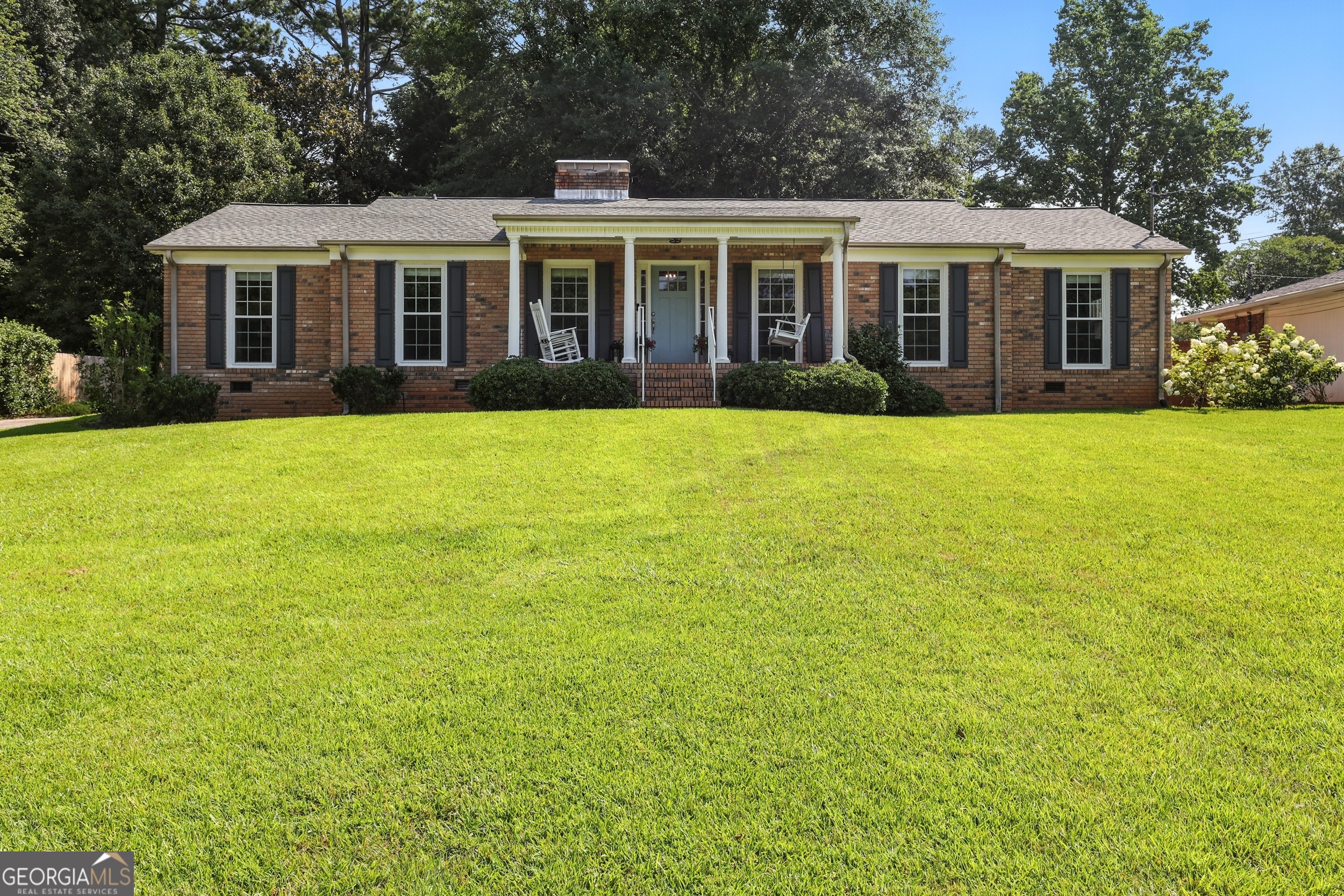 Welcome to this meticulously updated four-sided brick home in the heart of Toccoa, GA. Step through a generous foyer into the formal living and dining rooms that span the front of the home-perfect for hosting gatherings or welcoming guests. Ahead, discover a great room bathed in natural light, anchored by a cozy fireplace, and seamlessly open to a modern kitchen with breakfast bar-ideal for casual dining and family time. Recent updates include fresh paint, stylish backsplash, gorgeous new flooring, and upgraded fixtures throughout. Retreat to the tranquil bedrooms, refreshed and ready for personalization. Step outside to a level, privacy-fenced backyard-a serene space for kids, pets, or evening relaxation. A two-car carport beckons, alongside a versatile detached office-perfect for remote work, creative pursuits, or a home gym. This home blends timeless charm with thoughtful modern touches. From the inviting Southern-style front porch-ideal for rocking chairs and sweet tea-to the functional floor plan and move-in ready condition, this property captures the essence of comfortable, Southern living.
