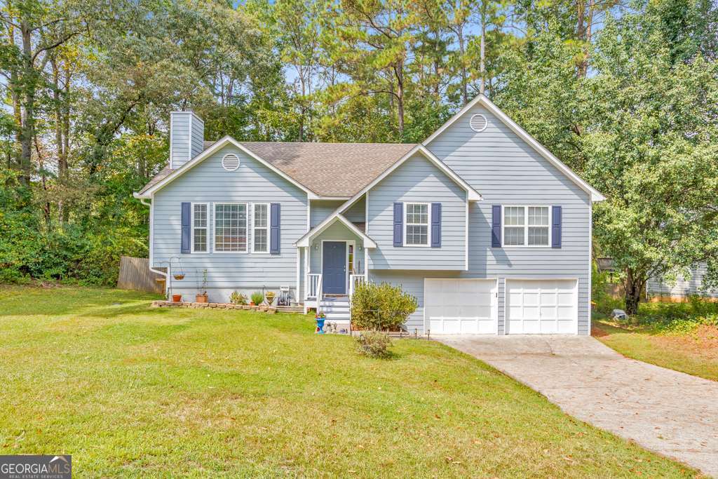 Welcome to this 4 bedroom, 3 bathroom home set on a private, wooded half-acre lot backing to Corps of Engineers property with scenic trails leading to Lake Allatoona. Step inside to a fireside family room with soaring vaulted ceilings, a separate dining room, and an updated kitchen featuring granite counters, a pantry, and abundant cabinet space. The primary suite offers tray ceilings, a spa-like bath with double vanities, a soaking tub, separate shower, and a walk-in closet. Two secondary bedrooms share a full bath, while the daylight basement provides a large bedroom with a sitting area, ensuite bath, and walk-out access-ideal for guests or an in-law suite. Enjoy outdoor living on the main-level deck or the covered terrace-level patio overlooking the spacious fenced backyard. An attached 2-car garage and a prime location near Downtown Acworth, I-75, shopping, dining, and Lake Allatoona make this home a perfect blend of comfort and convenience.