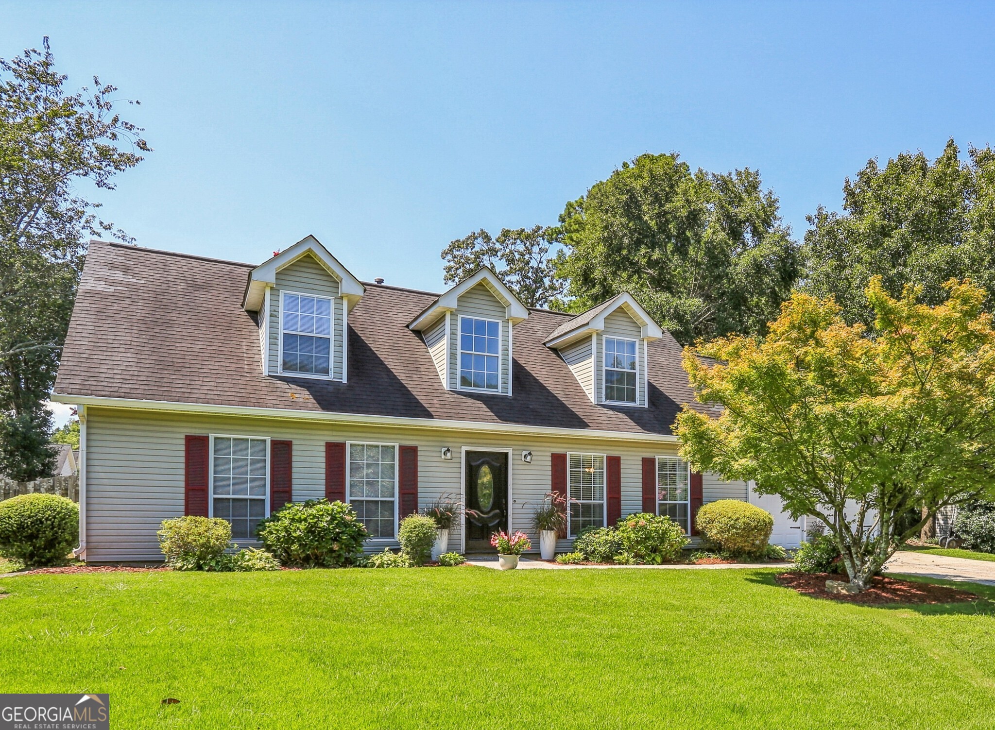 Welcome to this beautifully updated 4-bedroom, 2.5-bath Cape Cod-style home, perfectly situated on an oversized lot in the desirable Waterstone neighborhood. The professionally landscaped front yard and inviting curb appeal sets the tone for what's inside. Step into a spacious family room filled with natural light, flowing seamlessly into the formal dining room. The kitchen, updated just five years ago, features stainless steel appliances, crisp white cabinetry, and a stylish backsplash perfect for both everyday living and entertaining. The Great Room boasts a vaulted ceiling and cozy fireplace, creating a warm and welcoming gathering space. The first-floor primary suite offers comfort and privacy, with an updated bath showcasing an oversized vanity and walk-in shower. A second bedroom is also located on the main level, ideal for guests or flexible use. Upstairs, the versatile teen suite includes two additional bedrooms, a full bath, and a bonus study or workout room. All bedrooms feature ceiling fans for added comfort. Outdoors, enjoy a fully fenced, mature backyard designed for relaxation and entertaining, complete with two private patios one enhanced by a charming pergola. Recent updates include fresh laminate flooring throughout the first floor and a new water tank (2024). This home blends timeless character with thoughtful updates, offering both style and functionality in a wonderful community setting.