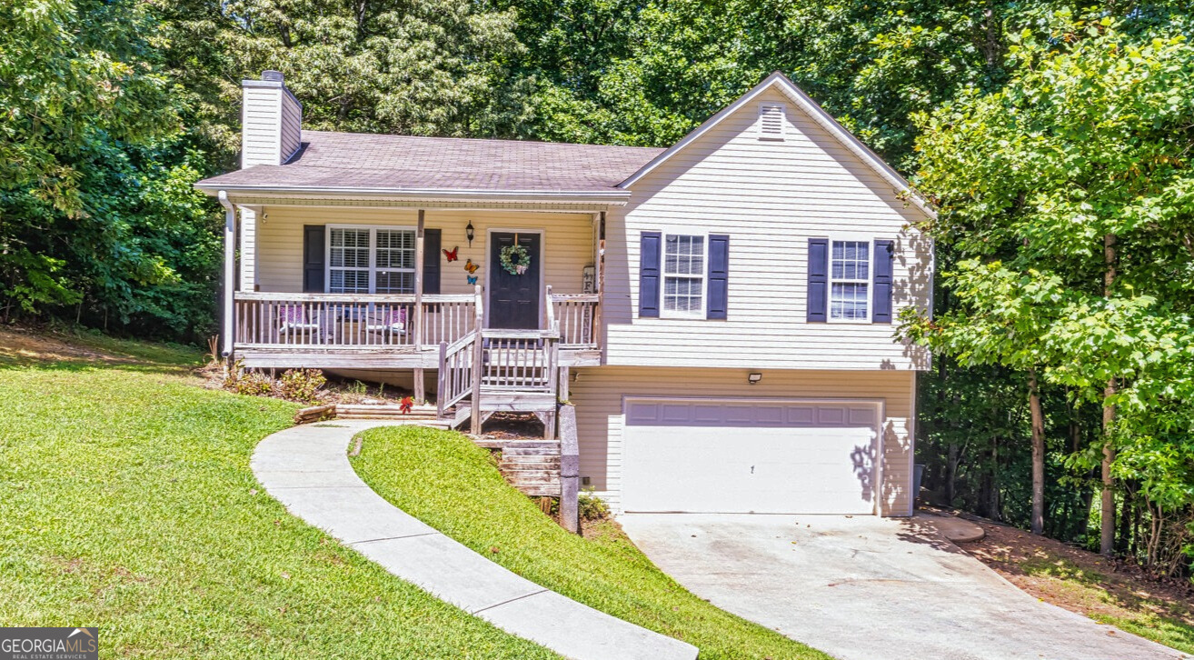Welcome to this well-maintained, move-in ready 3-bedroom, 2-bath home located in the desirable Paradise Landing neighborhood of Villa Rica. Situated on a quiet street with a large front yard and private fenced backyard, this home offers the perfect blend of comfort and potential. Inside, you'll find hardwood floors, a spacious family room with vaulted ceilings and a cozy fireplace, and a kitchen equipped with stainless steel appliances, including a microwave and refrigerator/freezer that remain with the home. The primary bedroom features a walk-in closet and en-suite bath, while the washer and dryer are also included for added convenience. The unfinished partial basement boasts high ceilings and sheetrock walls, offering plenty of opportunity to expand your living space. Additional highlights include a 2-car garage, HVAC system replaced in 2017, roof only 8 years old, and a new water heater to be installed before closing. Built in 2002, this home is the total package for buyers seeking space, value, and room to grow. Eligible for USDA financing with zero down payment, as well as FHA, VA, or Conventional loan options.