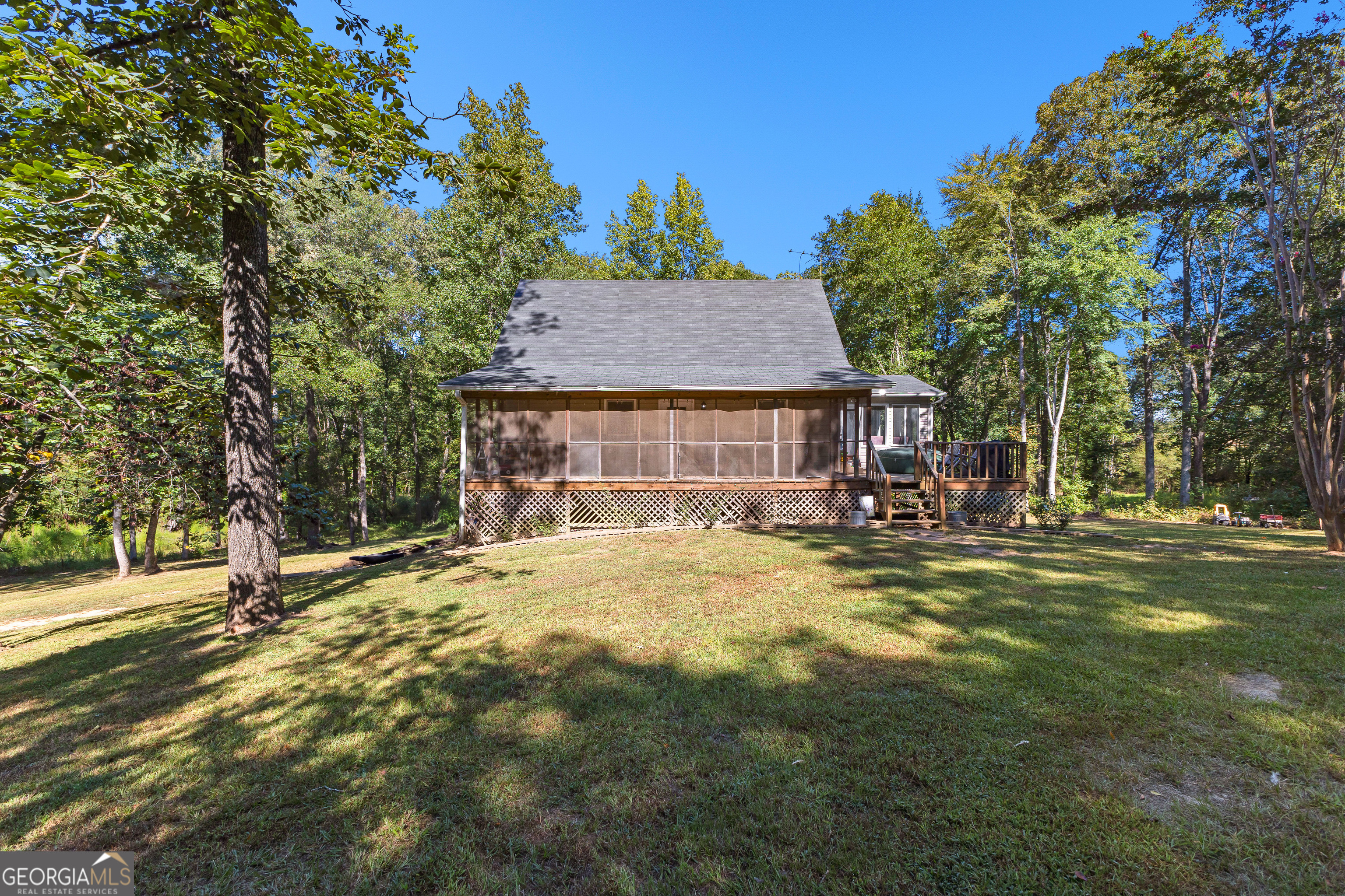 If your soul has been longing for a woodland retreat, look no further. Tucked away on 35 enchanting acres of hardwoods with a winding creek, this 3-bed, 2-bath home is a place where nature takes center stage. Imagine mornings with deer grazing just beyond the porch, afternoons filled with birdsong drifting through the trees, and evenings under a canopy of stars. The master suite on the main level provides a peaceful sanctuary, while two additional bedrooms upstairs welcome family and friends. The heart of the home is the open kitchen and living room, anchored by a cozy fireplace and filled with natural light and serene views of the forest beyond. Step outside to a screened-in porch and lounging deck, perfect for morning coffee or a sunset glass of sweet tea while listening to the sounds of nature. A partial basement with interior and exterior access adds versatility, and a charming chicken coop completes the picture of simple Southern living. This is more than a home-it's a retreat. A place where woods, wildlife, and warm memories are waiting to be made.