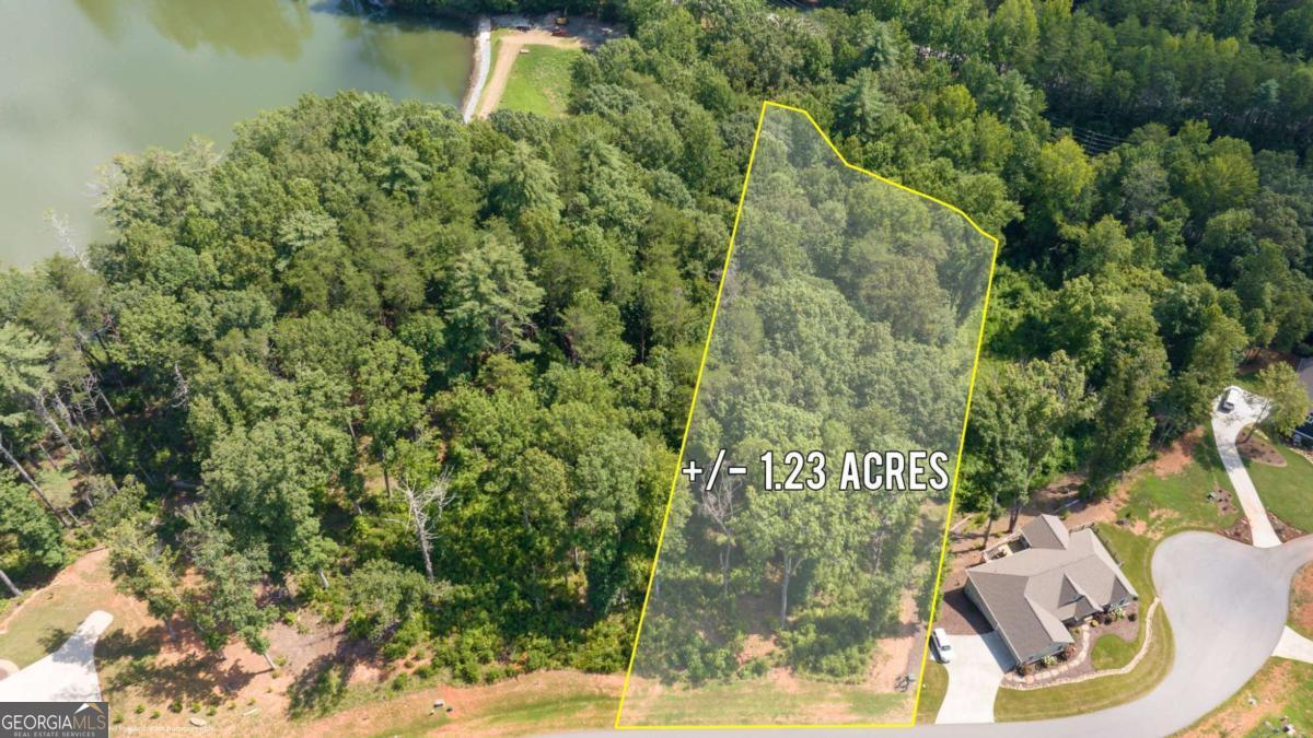 1.23 Acre Lot in the Prestigious Yonah Mountain Lake Community. Welcome to your mountain escape in the sought-after gated community of Yonah Mountain Lake. This expansive 1.23 acre lot offers both privacy and natural beauty, complete with a serene creek running along the entire back property line - the perfect spot to relax and unwind. Enjoy access to the private community lake just up the hill, ideal for fishing, kayaking, and enjoying the peaceful mountain setting. The neighborhood features a gated entrance, a charming pavilion with a stone fireplace, grill, and a dock that extends into the lake - perfect for entertaining or soaking in the views. Nature lovers will appreciate direct access to the National Forest for hiking, and the property's close proximity to Helen, Cleveland, Unicoi State Park, and all the adventures the North Georgia Mountains have to offer.