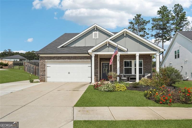 BETTER THAN NEW. Fully updated / upgraded ranch home under three years old. Step-less, open concept, energy efficient home adorned with custom millwork, board and batten, wainscotting, and upgraded trim. Main level includes master bedroom + 2 secondary bedrooms + office. Hardwood floors lead you through the foyer and by two large secondary bedrooms as you enter the home. There is a flex room that could be used as a play room, media room, office, or secondary family room. A spacious, open kitchen with an oversized granite island greets you as you enter into the living areas and a large great room with gas log fireplace. Kitchen features an oversized island with quartz countertops, stainless steel appliances, and large eat-in kitchen. Master on Main: Spacious primary bedroom on main w/ trey ceiling, custom millwork, and a spa-like bathroom with an over-sized zero entry step-less shower, double vanities, and a large walk-in closet. Upstairs includes a large loft area, bedroom, and full bath. Level driveway and 2 car garage w/ opener. Home sits on a premium corner lot with a large fenced-in yard. An expanded driveway continues on the side of two car garage to the back yard - room enough for 5+ cars without street parking. This home was built to be energy-efficient. Towne Mill Community has resort-like amenities including a pool w/ splash pad and slide, tennis courts, baseball field and a basketball court. Subdivision located next to the Hickory Log Lake - great for fishing and kayaking. Top-rated schools and close to shopping and easy access to I-575.